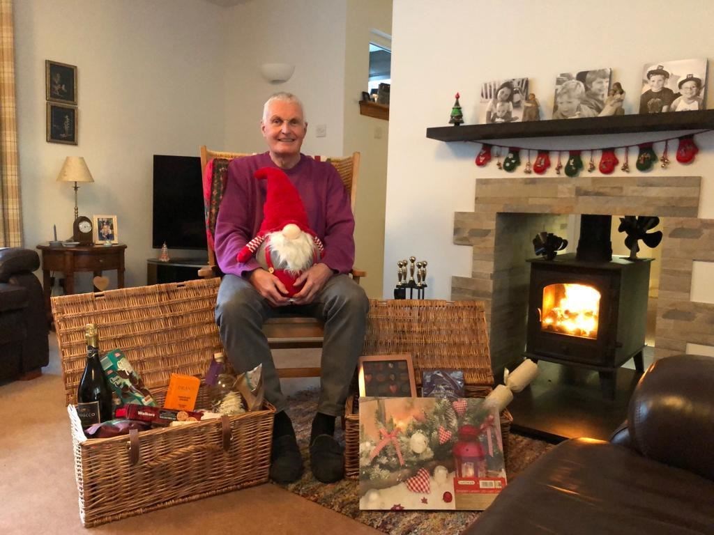 Davie Small with the Rotary Elgin Christmas Lucky Stars win, which he has donated to Moray Food Plus.