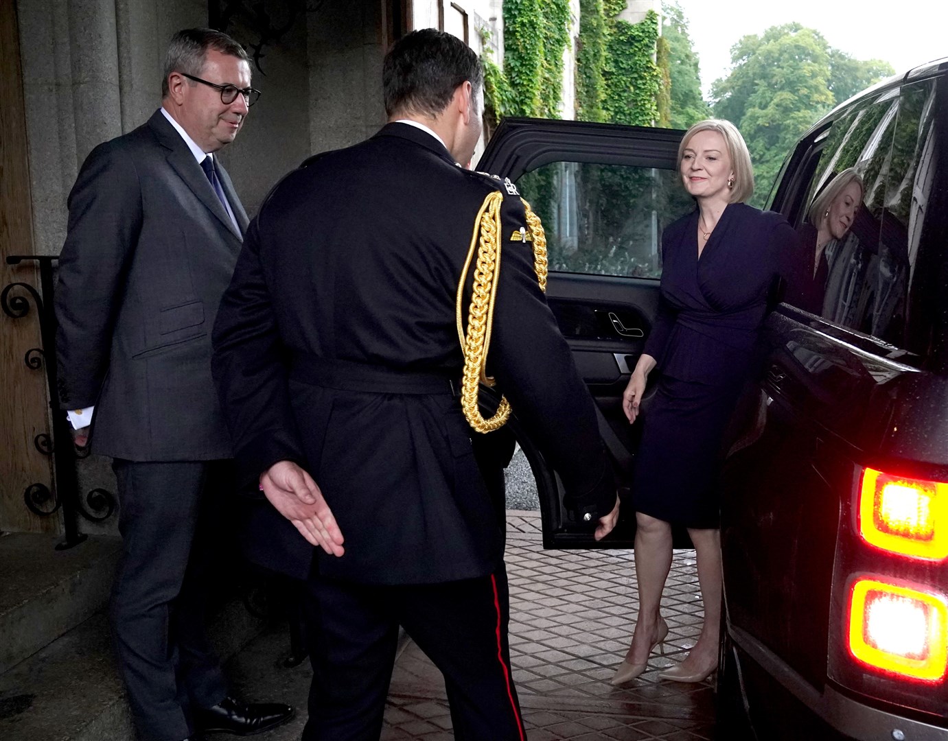 Liz Truss was greeted by the Queen’s equerry Lieutenant Colonel Tom White and her private secretary Sir Edward Young as she arrived at Balmoral (Andrew Milligan/PA)