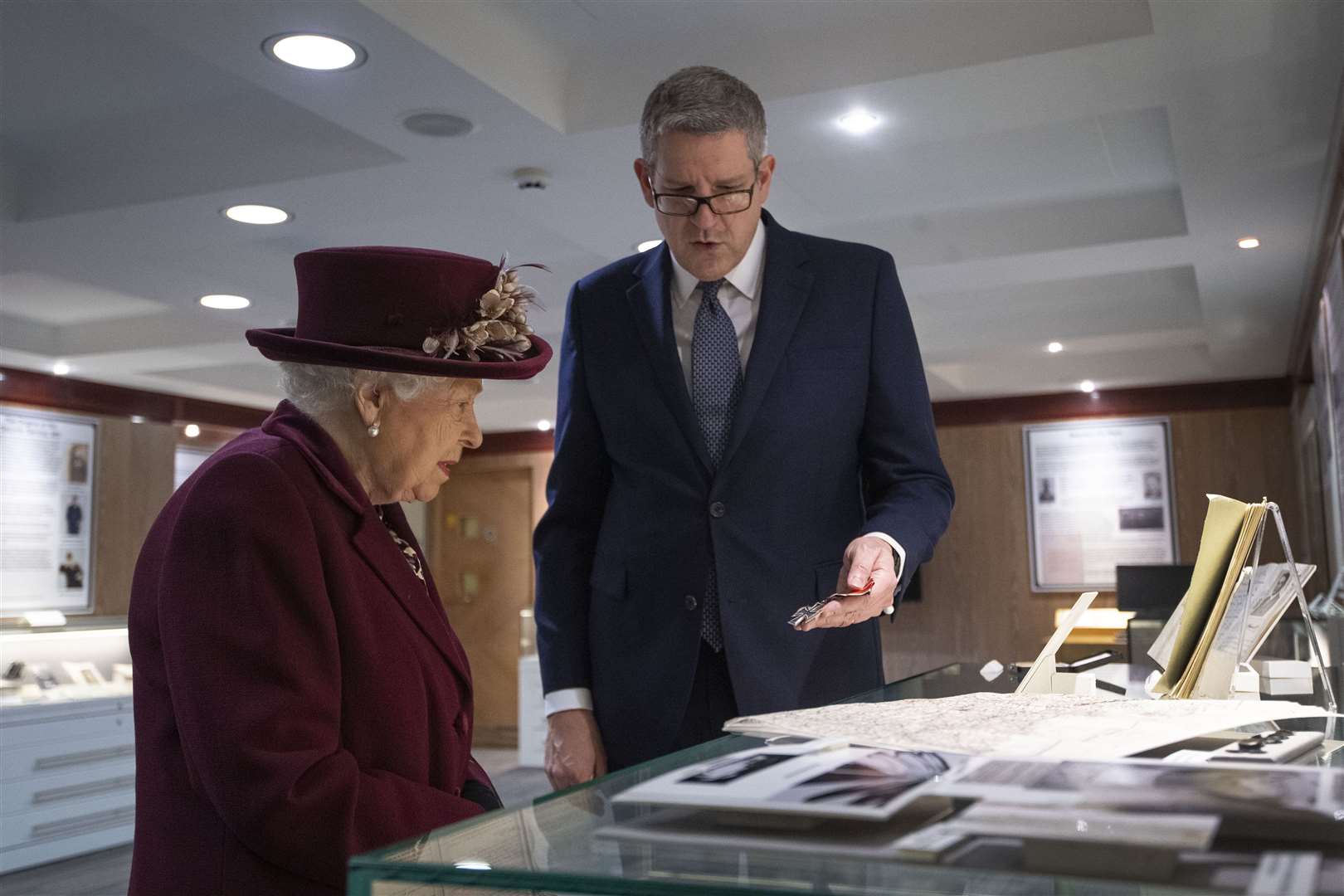 Baron Parker shows the Queen artefacts relating to MI5’s D-Day operations during her visit to the intelligence agency (Victoria Jones/PA)