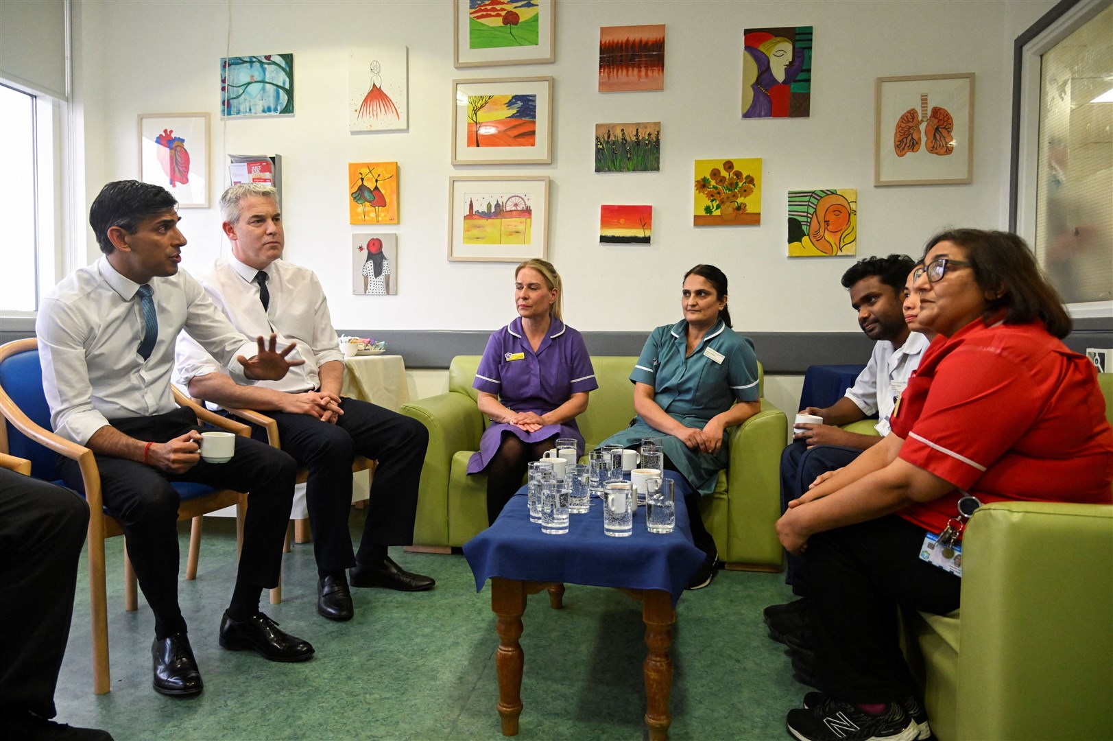 Rishi Sunak, left, spoke with staff during a visit to St George’s hospital in London (Toby Melville/PA)