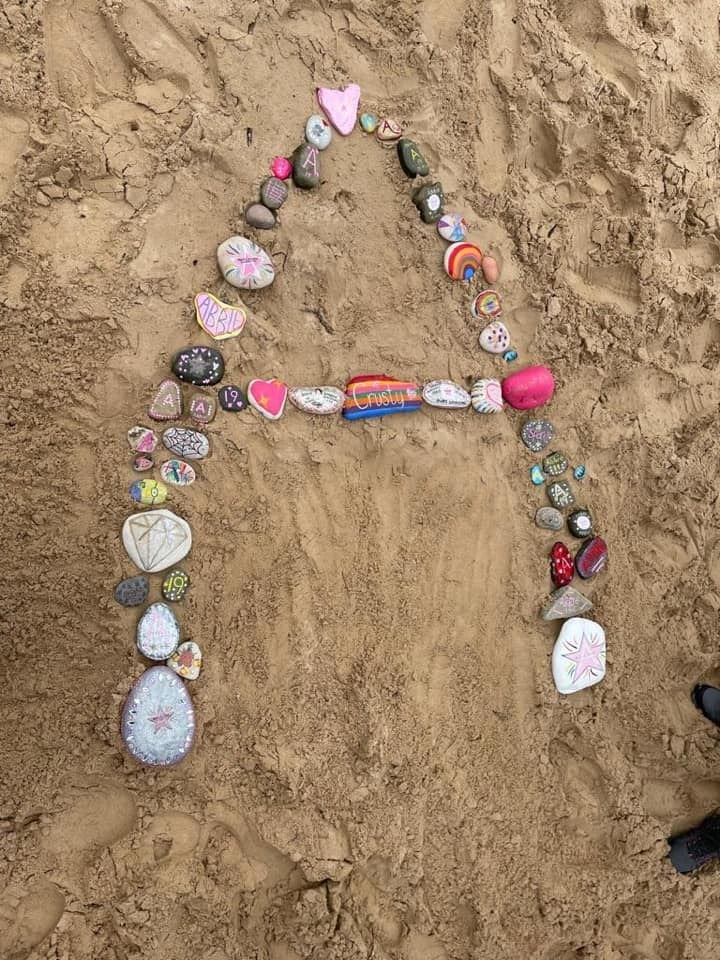 Abbie's initial in decorated stones at Roseisle beach.