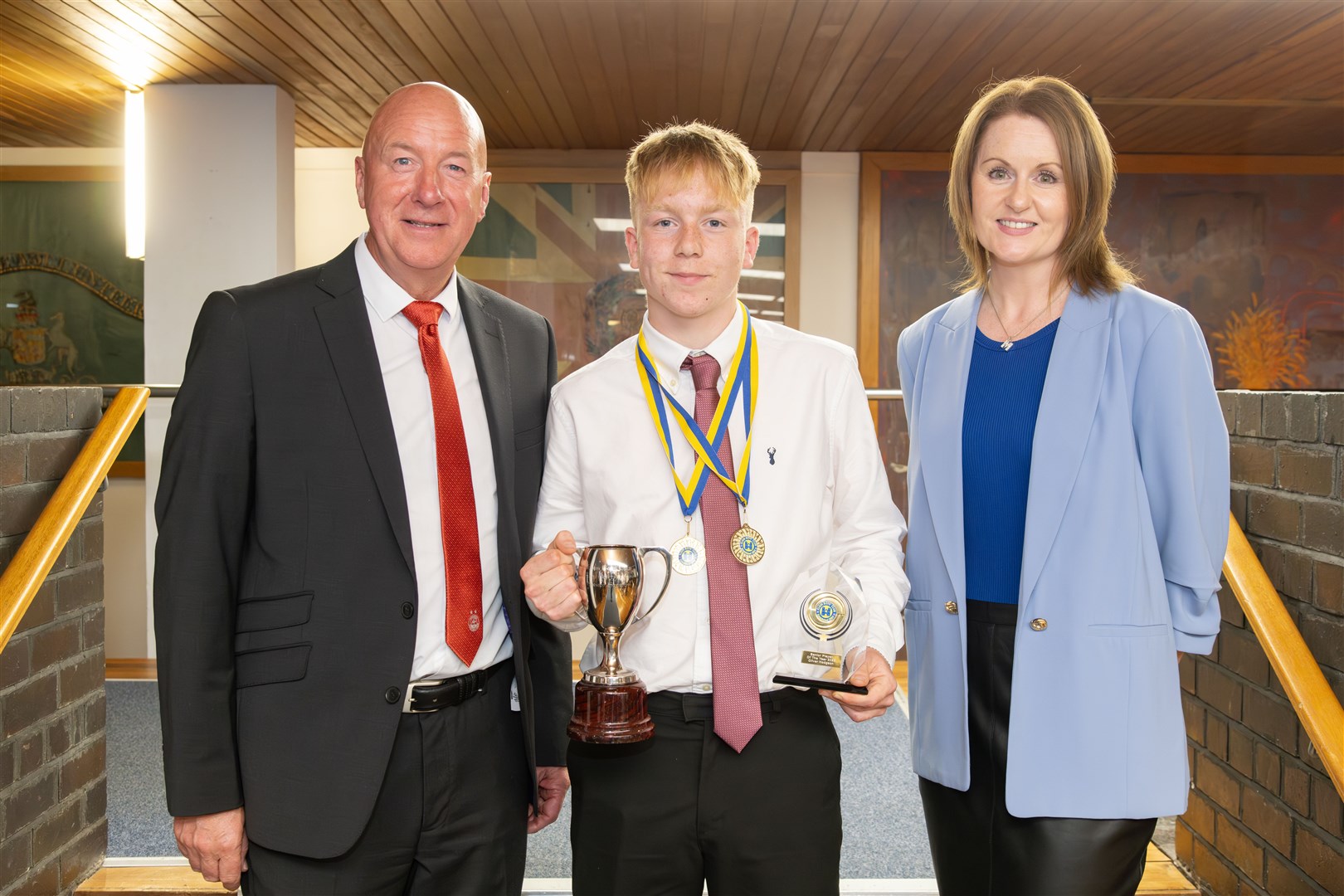 Oliver Hodgson was Elgin Boys' Club's senior player of the year.,pictured with Neil Simpson and Margaret Ramage. Picture: Beth Taylor.