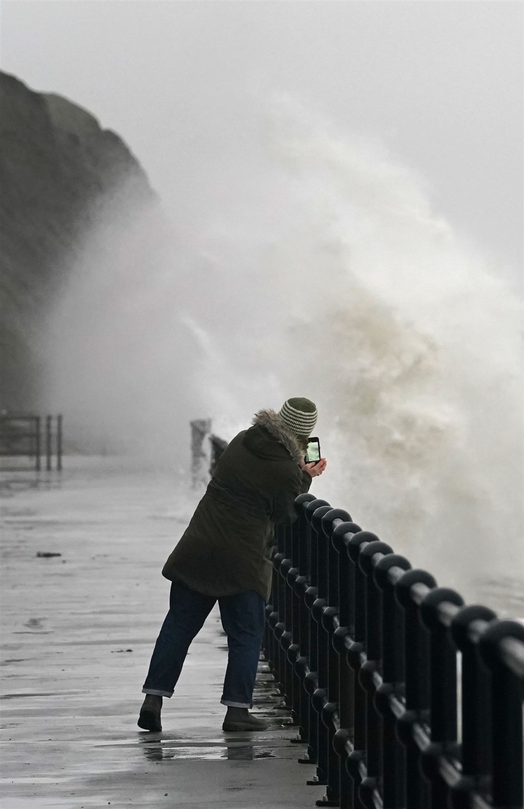 Waves crashing over the promenade during rain and strong winds in Folkestone, Kent, on Tuesday (Gareth Fuller/PA).