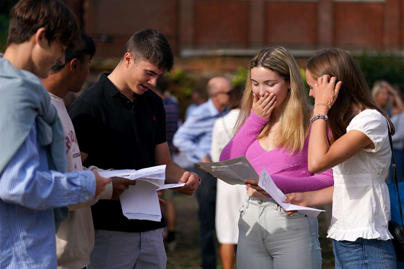 Anna Austin, centre right, reacts when reading her A-level results at Norwich School (Joe Giddens/PA)