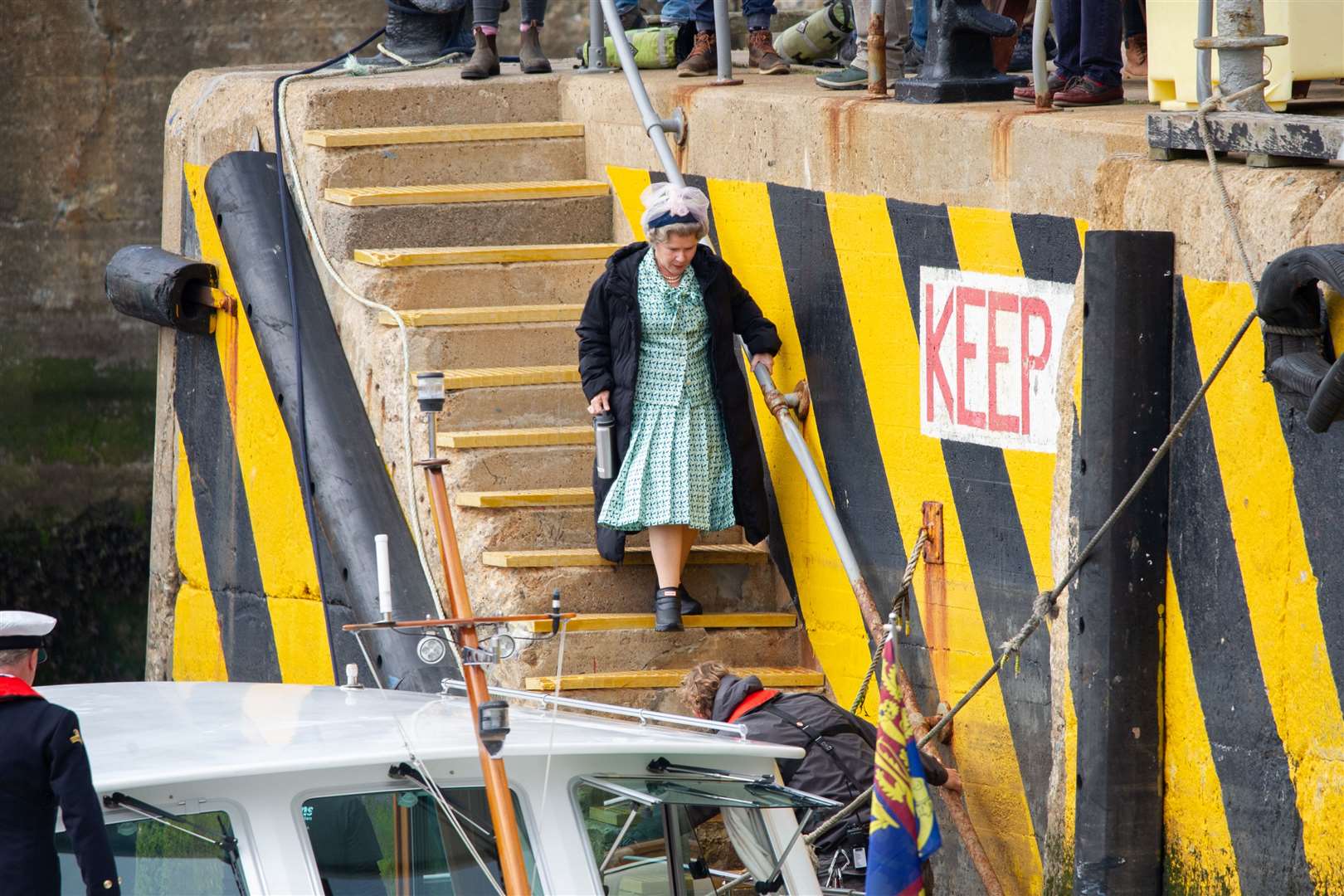 Imelda Staunton makes her way down steps to board a vessel at Macduff in filming for The Crown. Picture: Daniel Forsyth.