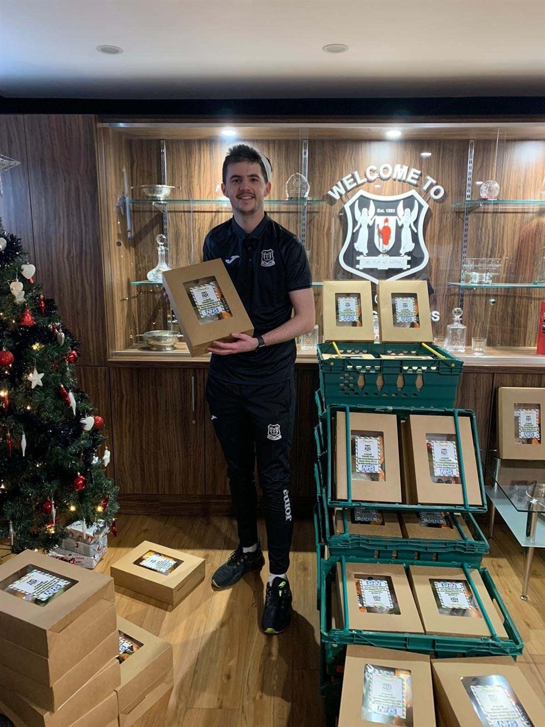 Keiran Carty prtpares hampers in the Elgin City office