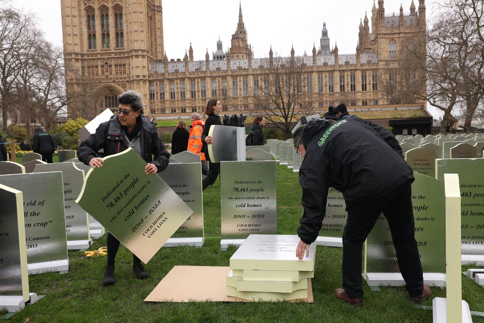 Protesters installing “headstones” made from insulation boards outside the Palace of Westminster in London (Alex McBride/Greenpeace/PA)