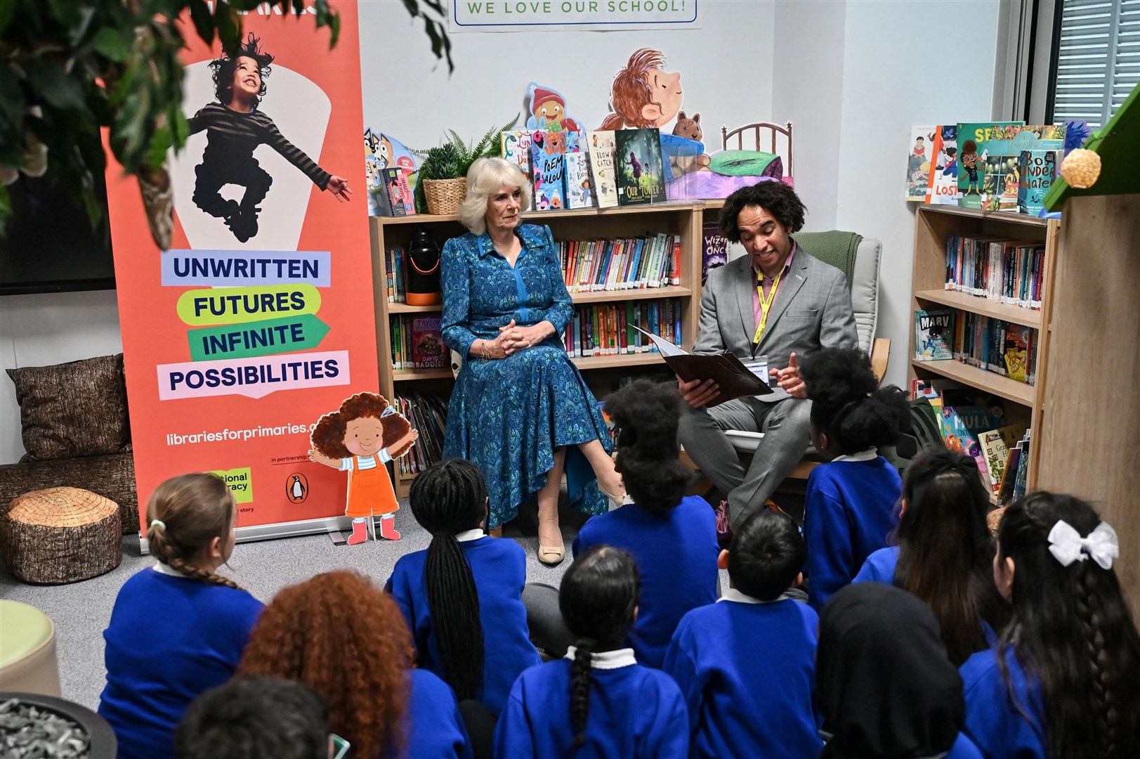 Queen Camilla and pupils listen to Waterstones Children’s Laureate and poet Joseph Coelho (Justin Tallis/PA)
