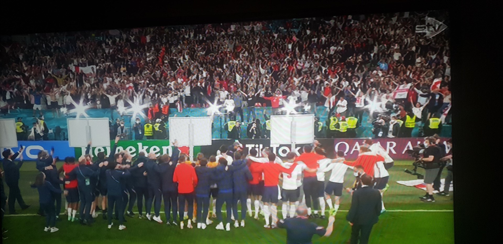 The England team celebrate with their fans.