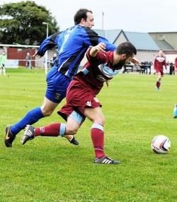Huntly's John Urquhart battles with Keith's Ryan Stewart during Saturday's Highland League game. Photo by Eric Cormack.