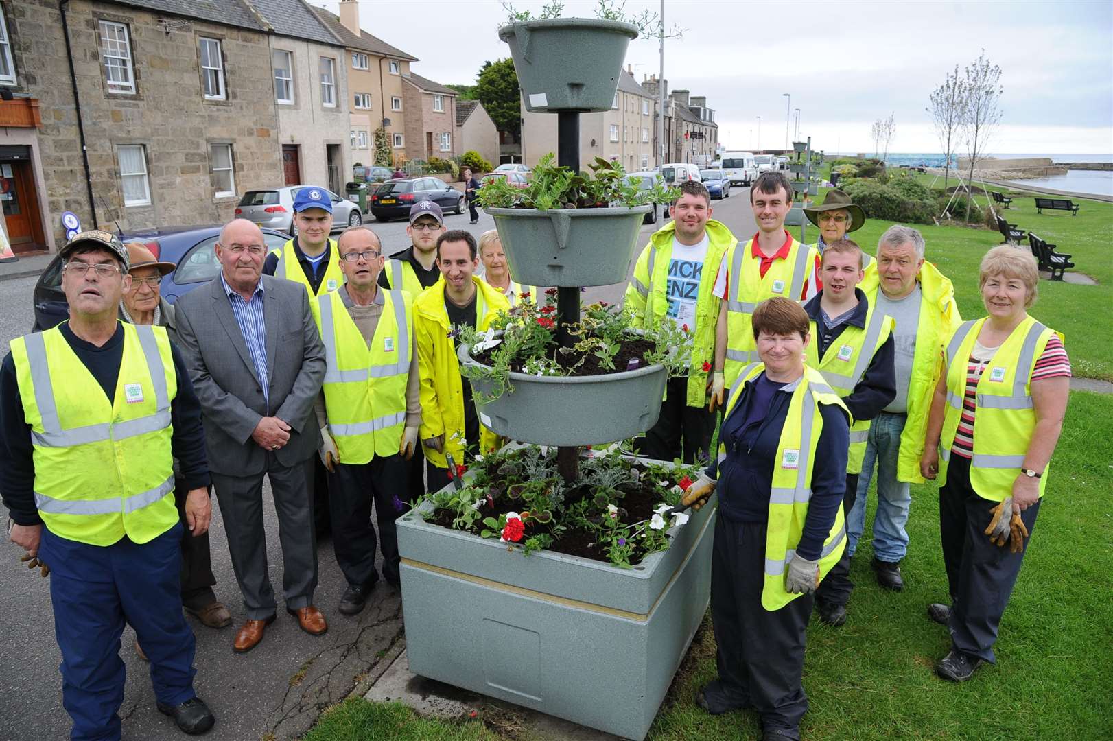 Mike, third from left, celebrating some of the new floral displays in the town in 2014.