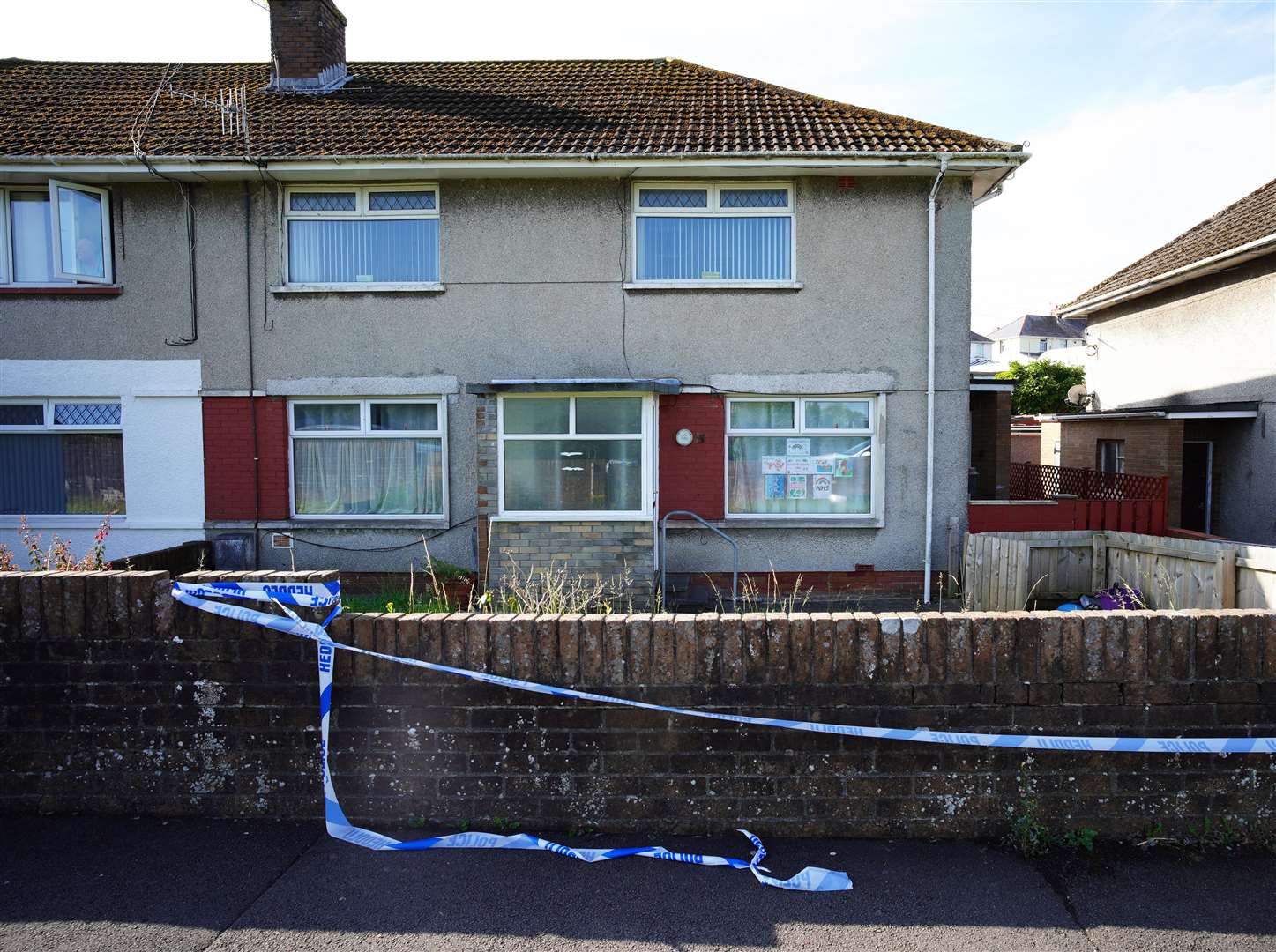 Police tape at a property in the Sarn area of Bridgend (PA)