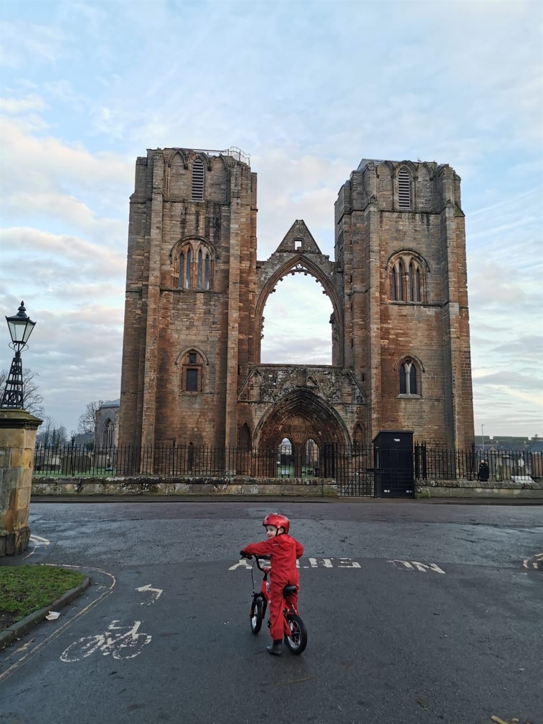 Archie pictured outside of Elgin Cathedral on one of his cycles.