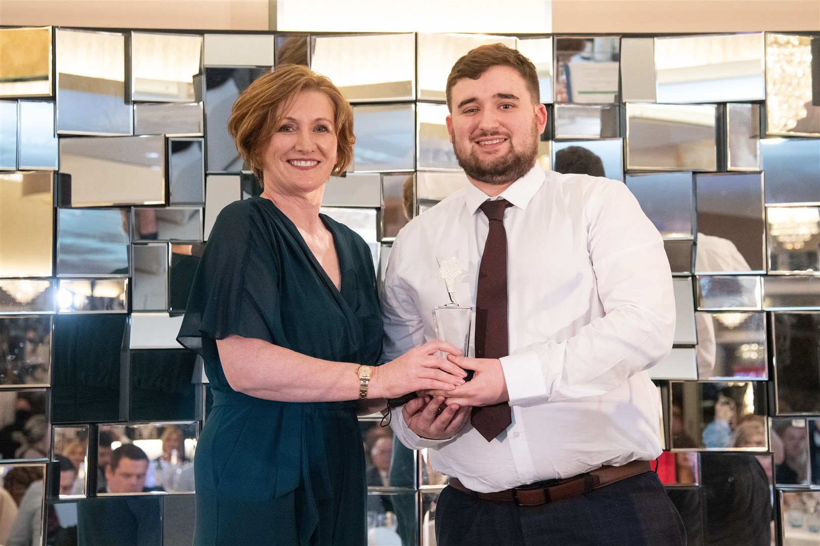 Sean Christie collects the carer award on behalf of his grandmother Lorraine Taylor from Elaine Taylor (no relation) of award sponsor Parklands. Picture: Daniel Forsyth