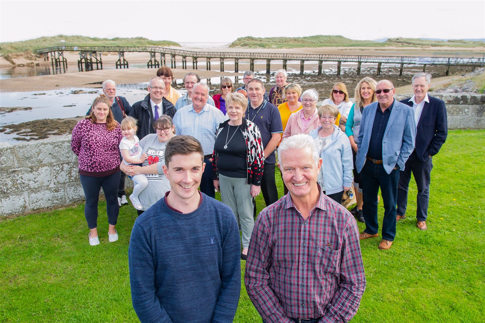 Members of the Lossiemouth community, including (front from left) Community Development Trust's chairman Alan Macdonald and development trust officer Huw Williams, welcome news that the Scottish Government will cover the full cost of repairs or a replacement for the Lossiemouth East Beach bridge. Picture: Daniel Forsyth. Image No.044677.