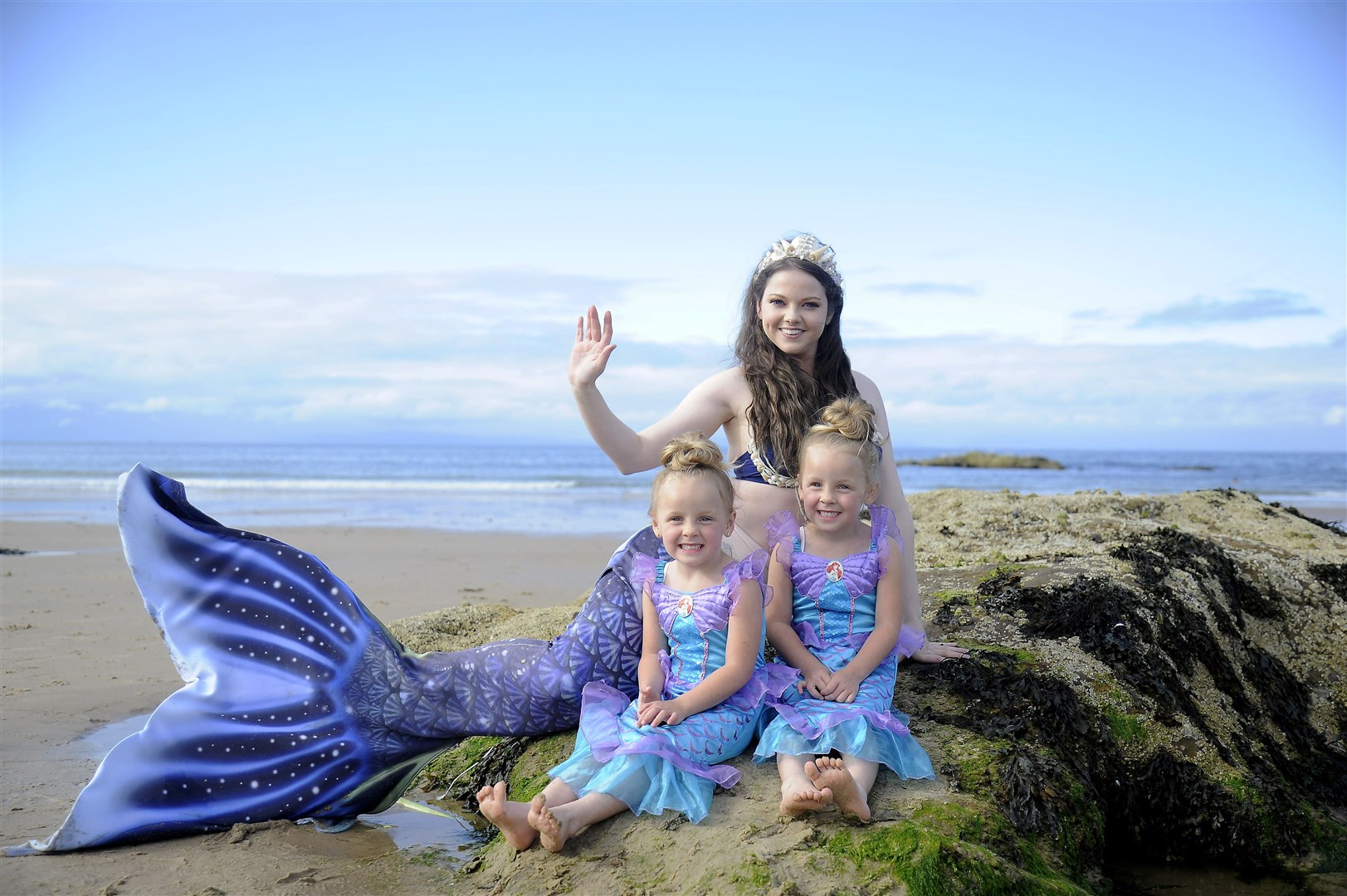 A wave from Ashleigh as she meets these little mermaids. Picture: Becky Saunderson