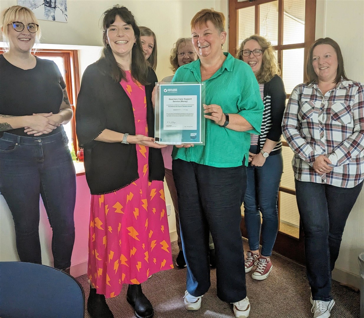 The Moray Carers Support Service team met with Becky Duff; Director of Carers Trust for Scotland to receive their award. Pictured are: Sophie Smith; Becky Duff; Anna Mackay; Fiona Imlach; Sandi Downing; Liza Campbell and Lee-Anne Blaney