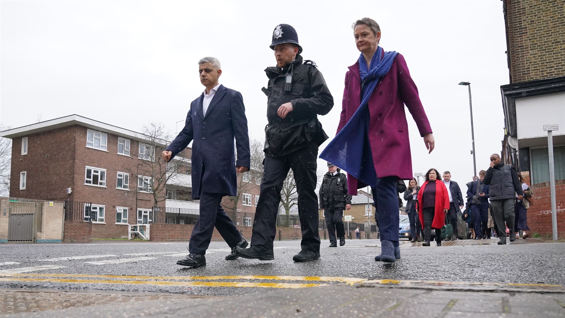 Mayor of London Sadiq Khan and shadow home secretary Yvette Cooper during a walkabout with a police officer in Earlsfield (Jonathan Brady/PA)