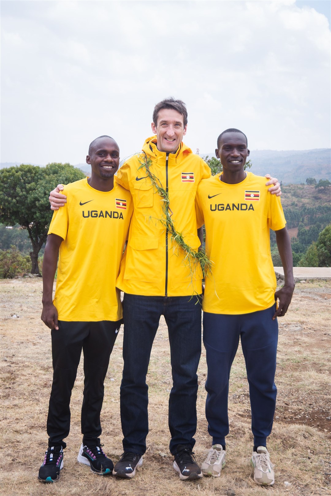 Jacob Kiplimo (left) and Joshua Cheptegei (right) posing with Rob Walker (Ugandan Tourism Board)