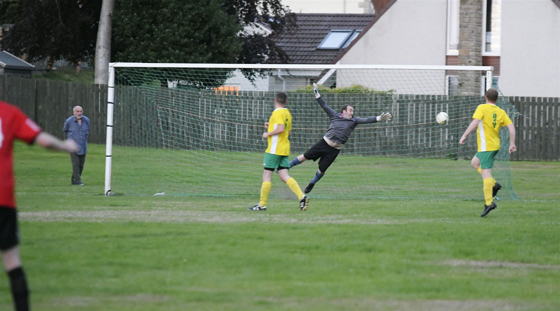 Fochabers' fifth goal by Gary Burchell flies past Hopeman keeper Darren Wood. Picture: Beth Taylor