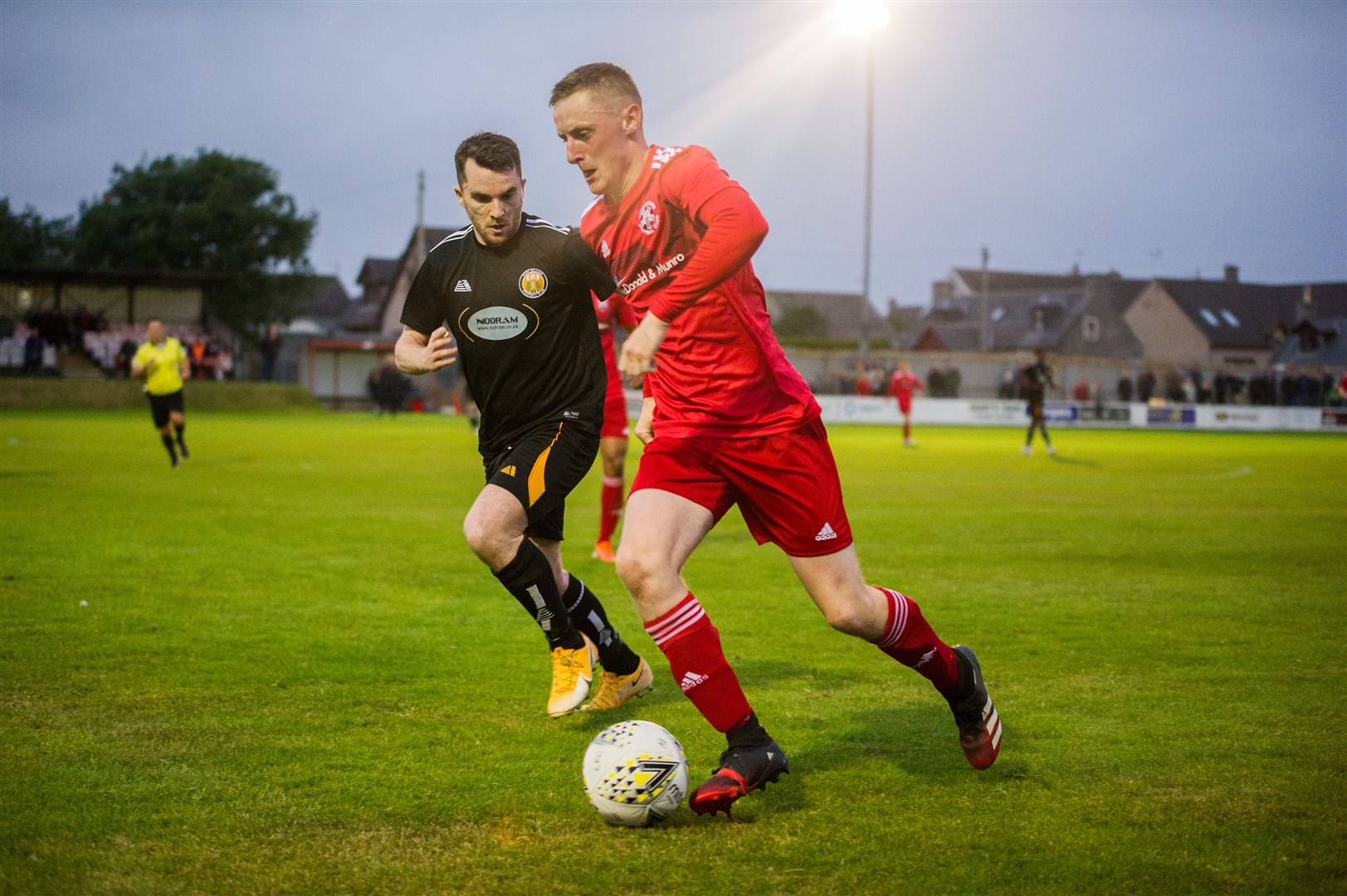 Lossie full back Michael Weir takes on Fort's Mark Mackenzie. Picture: Becky Saunderson..