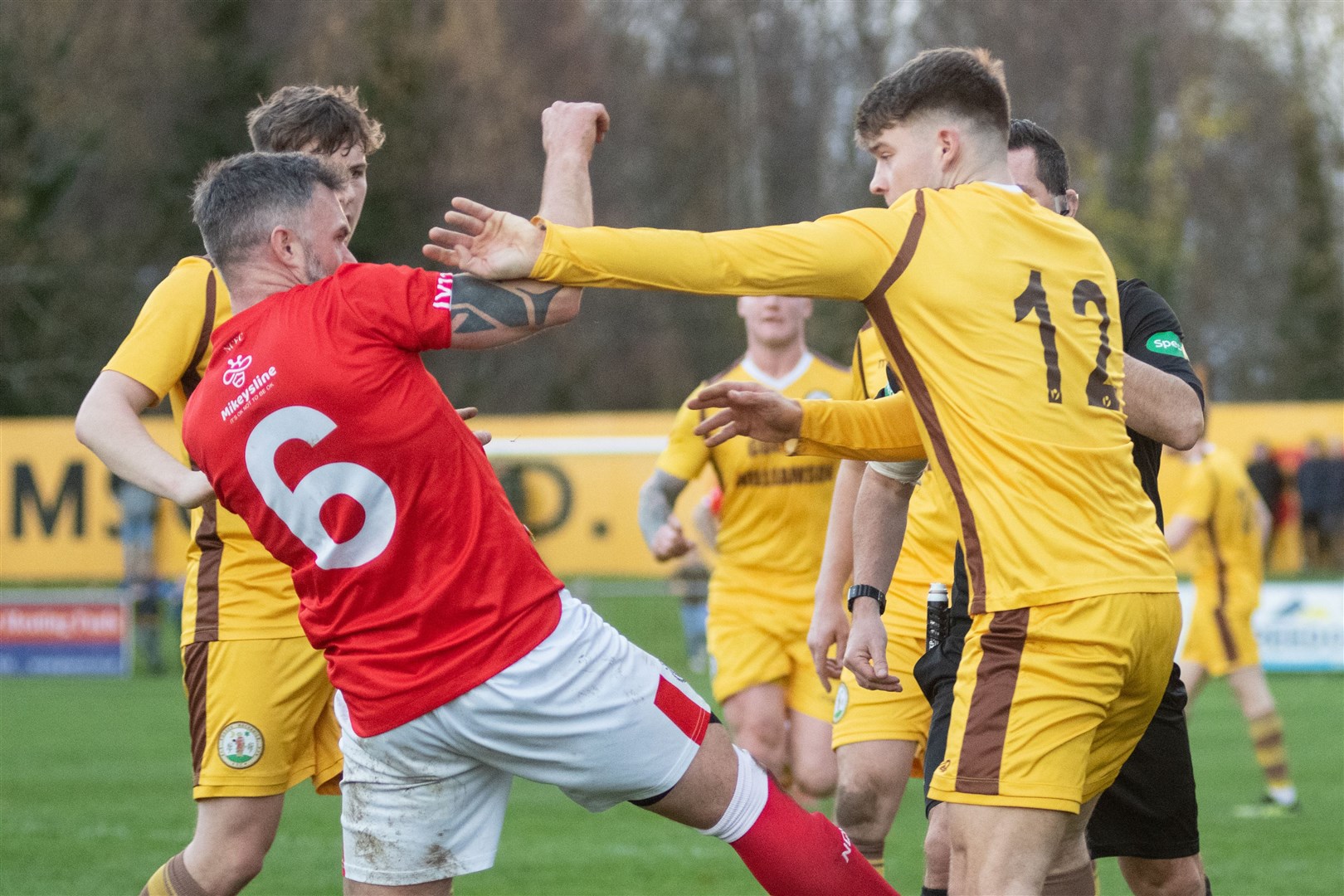 Tempers flare between Forres Mechanics' Jack Grant and Nairn County's Wayne MacKintosh...Forres Mechanics FC (3) vs Nairn County FC (4) - Highland Football League 22/23 - Mosset Park, Forres 26/11/2022...Picture: Daniel Forsyth..