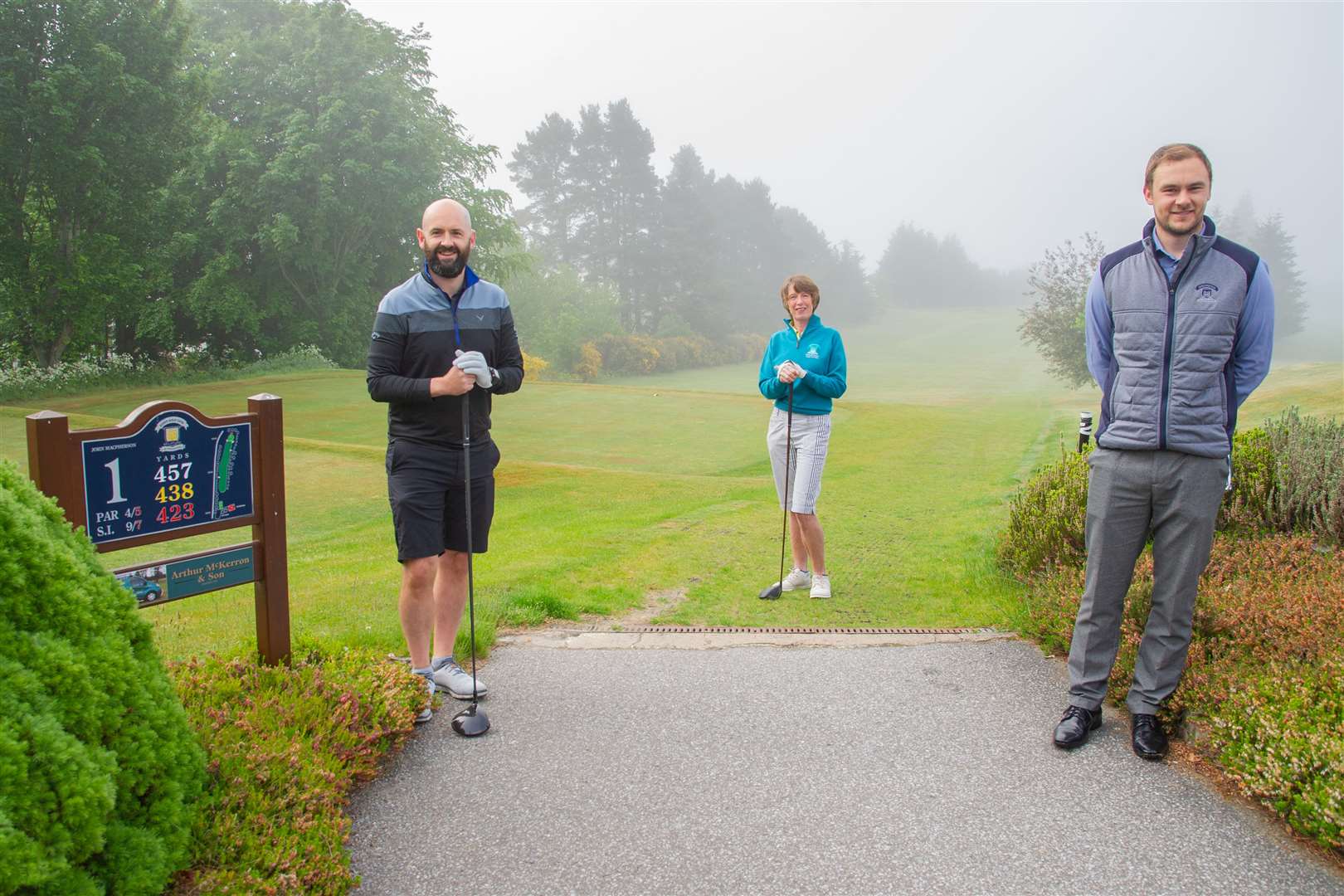 The first hit since lockdown. Elgin Golf Club professional Michael McAllan, club captain Marian Evans and club manager John Duguid celebrate the reopening after more than two months of shutdown. Picture: Daniel Forsyth..