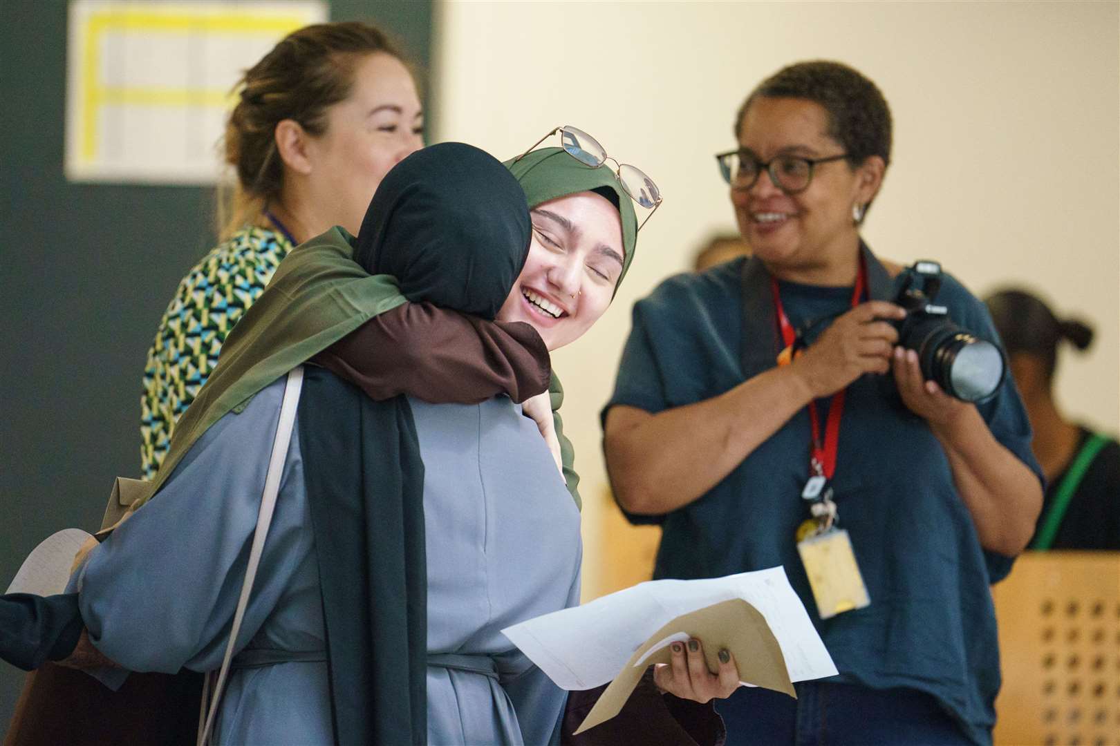 Elanur Tankisi, centre, is congratulated as she receives her A-level results at Oasis Academy Hadley, Enfield, north London (Dominic Lipinski/PA)