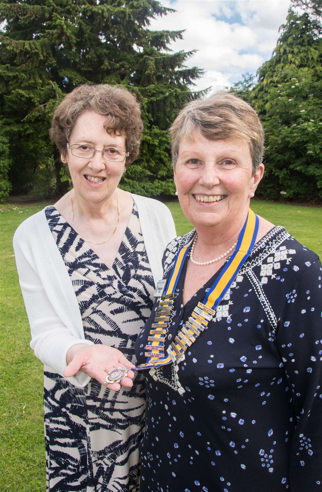 Bertha Ritchie hands over the Inner Wheel chain to new president Marjorie Duthie. Picture: Becky Saunderson. Image No.044218.