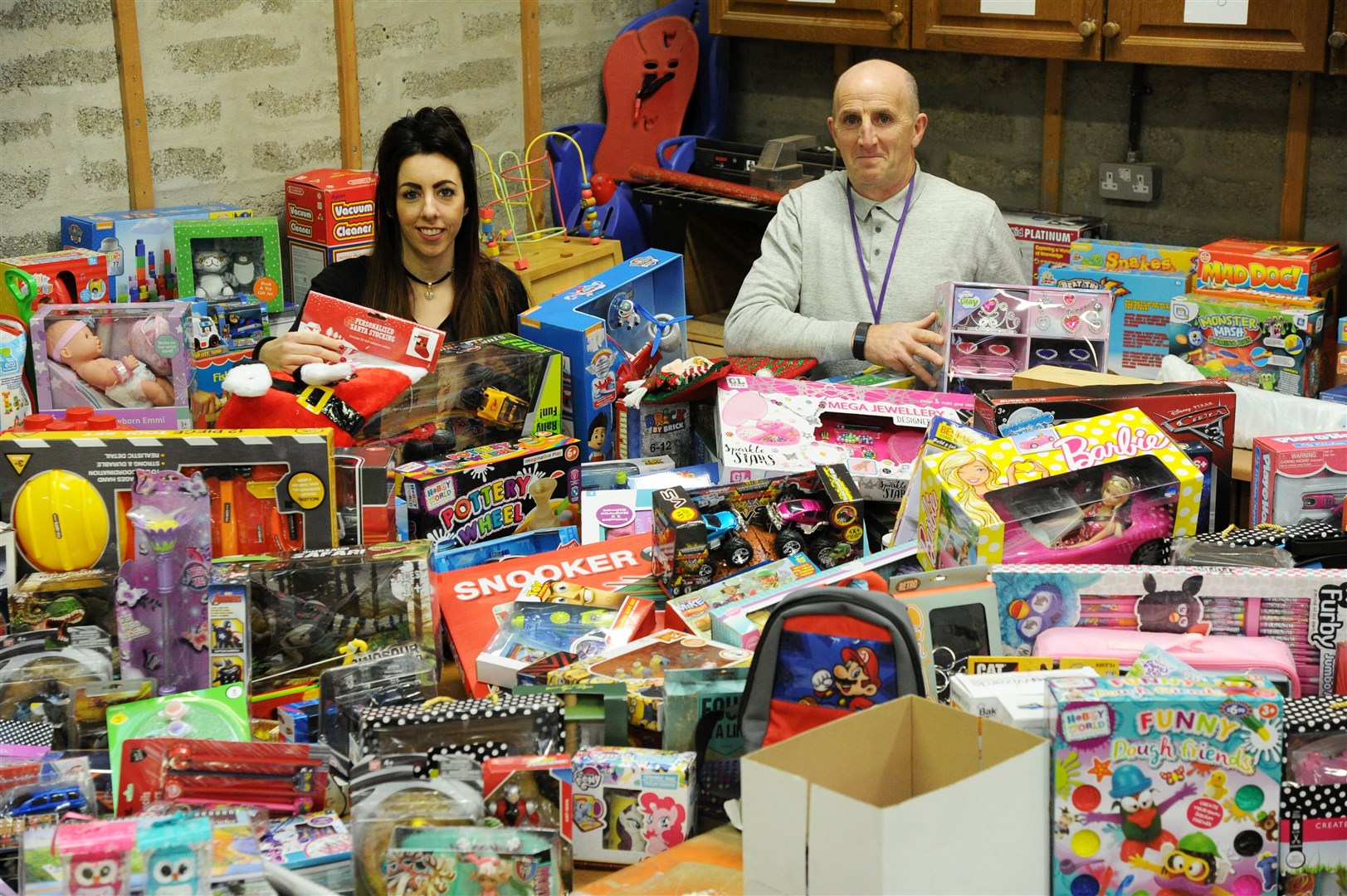Cheryl Burchell of the Northern Scot and Peter Henderson of Moray Council social work department with some of last year's donations. Picture: Eric Cormack.