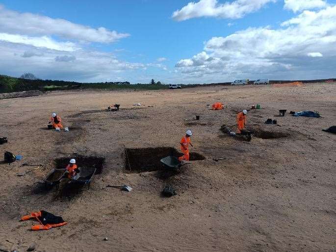 Excavations of a large Iron Age enclosure ditch.
