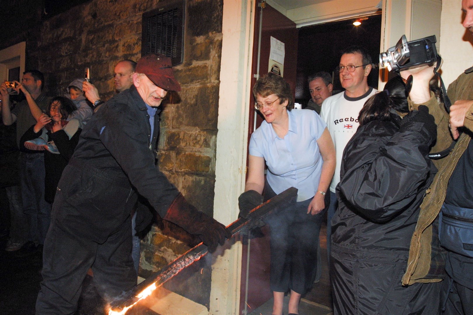 A burning stave is handed out in 2004.