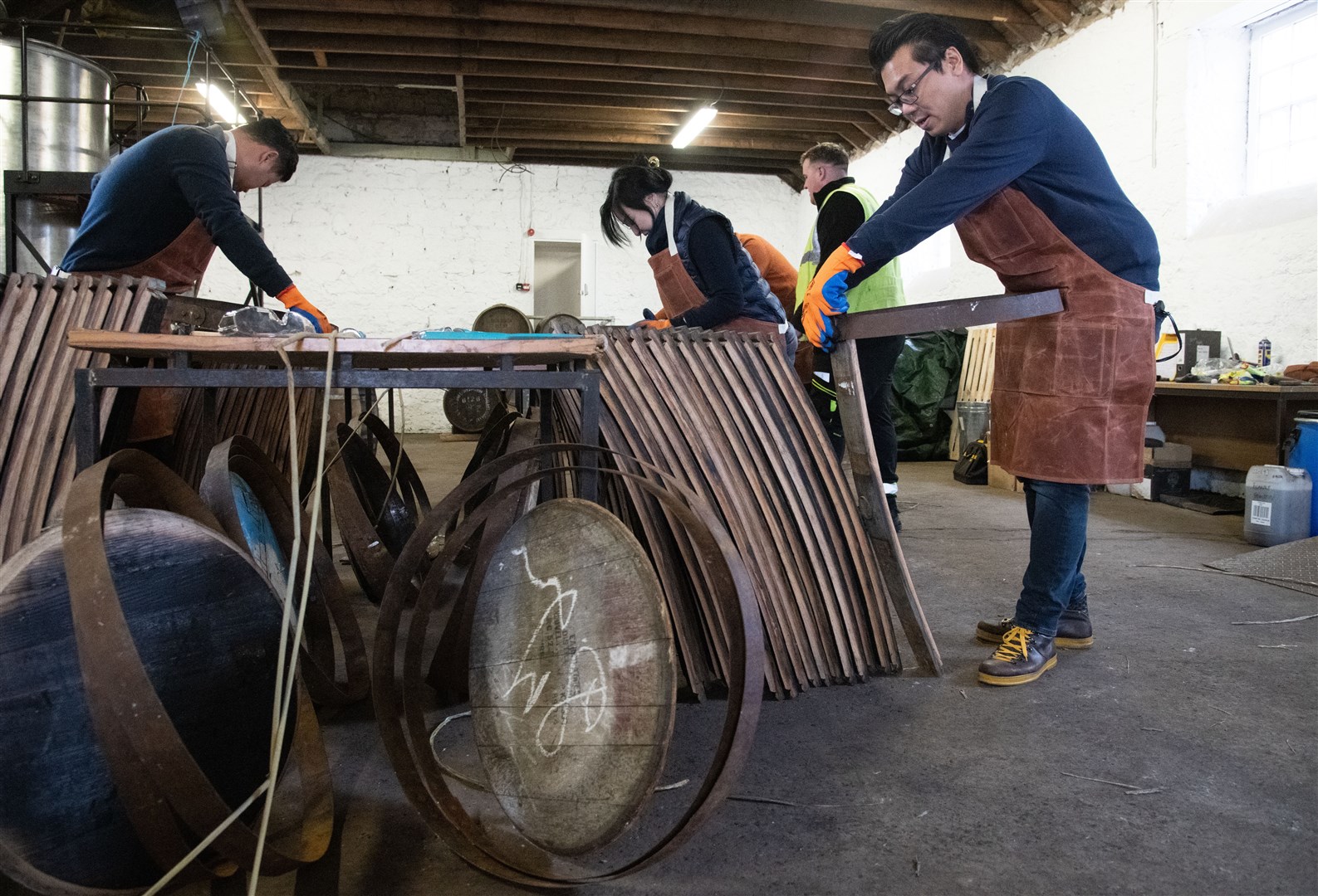 Roll out the barrel. The visitors enjoyed the cask-making session at Coleburn Distillery. Picture: Daniel Forsyth
