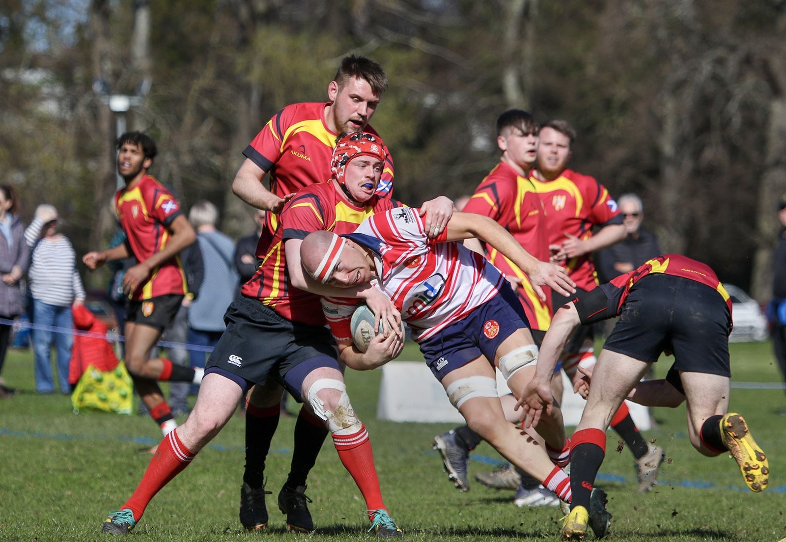 Three players move in to tackle Lewis Small. Picture: John MacGregor