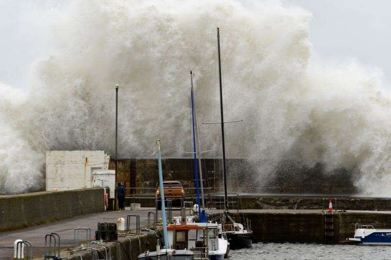 The waves crash high into the air as the sea pounds Hopeman harbour. Picture: Steve Arkley