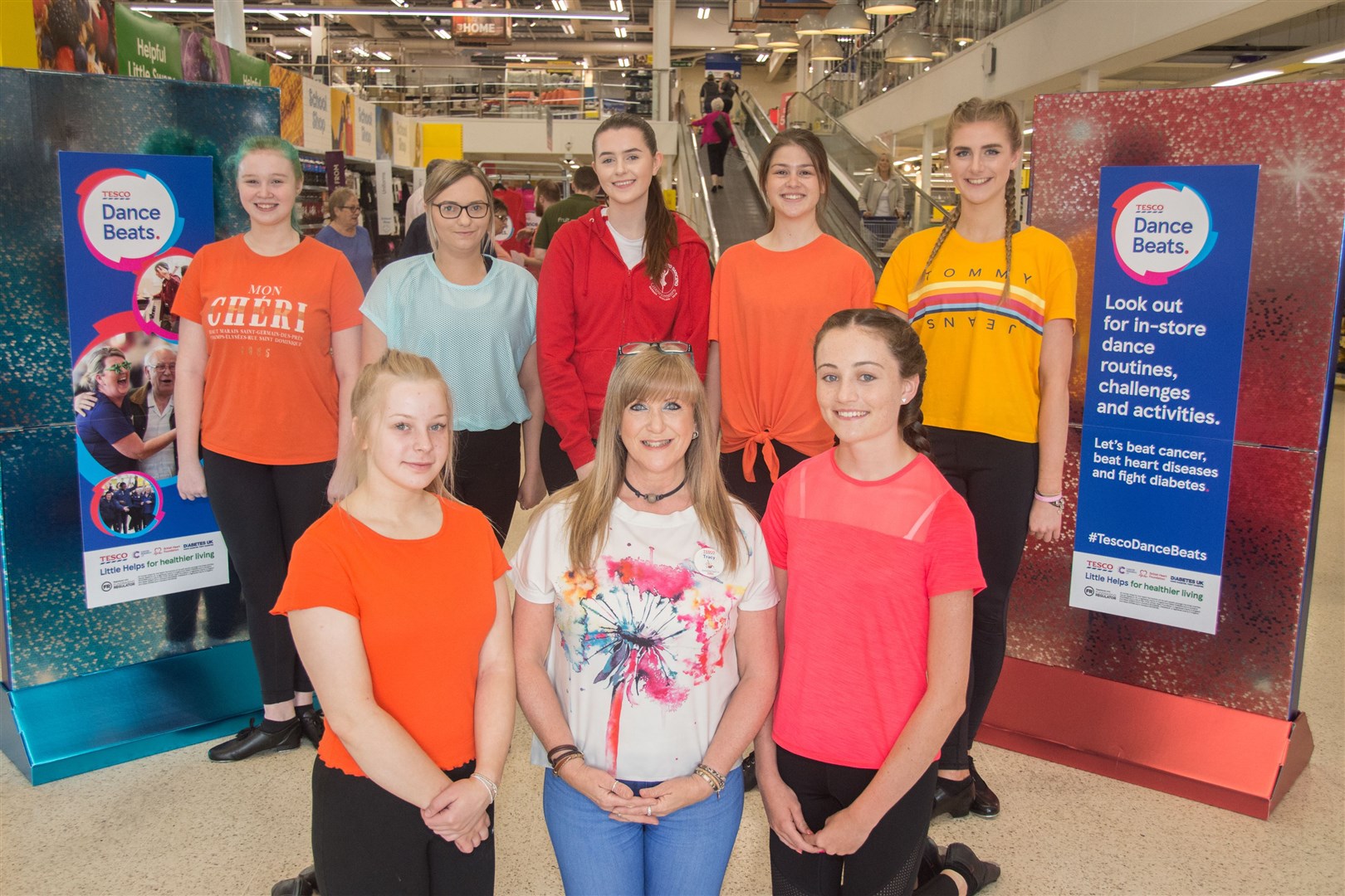 Elgin dancers are back from left Lucy Black, Lauren Petrie, Destiny Gourlay, Fiona Reuss-Newland and Shona Cumming with Mia Fraser (front left) and Leona Laing with Community Champion Tracy Gourlay (front centre)...Dancers and circus performers were at Tesco Elgin to mark 100th anniversary. ..Picture: Becky Saunderson. Image No.044466.