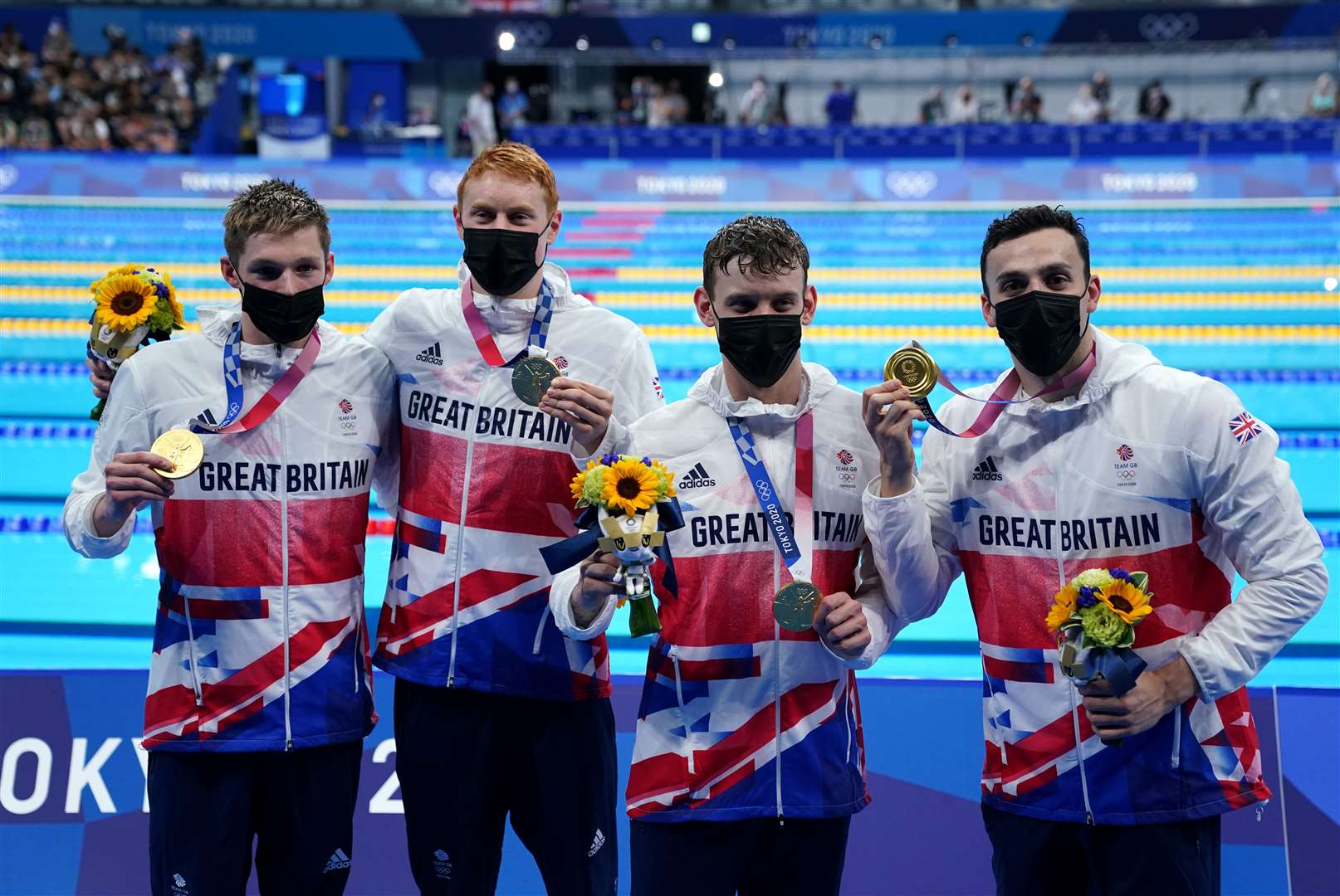 Team GB’s Duncan Scott, Tom Dean, Matthew Richards and James Guy celebrate gold in the men’s 4×200m freestyle relay at Tokyo Aquatics Centre (Adam Davy/PA)