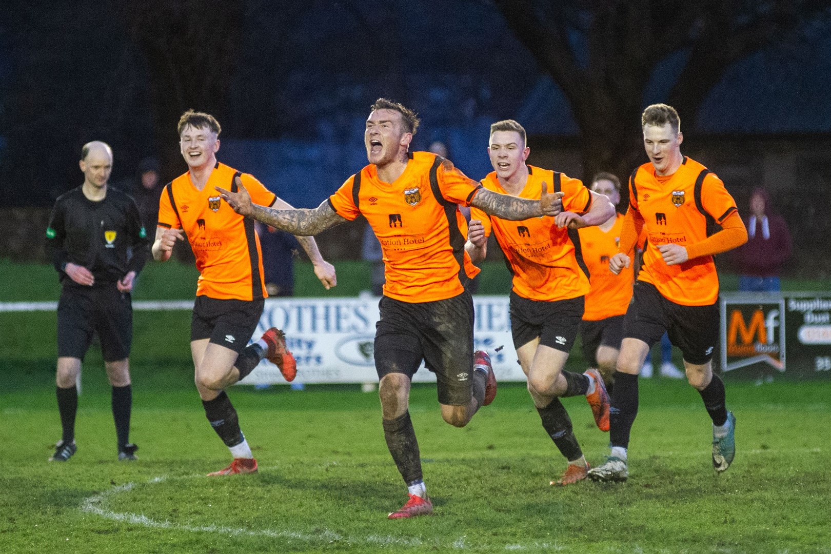 Elgin City loan player Darryl McHardy leads a Rothes celebration after scoring the winner against Strathspey Thistle. Picture: Daniel Forsyth..