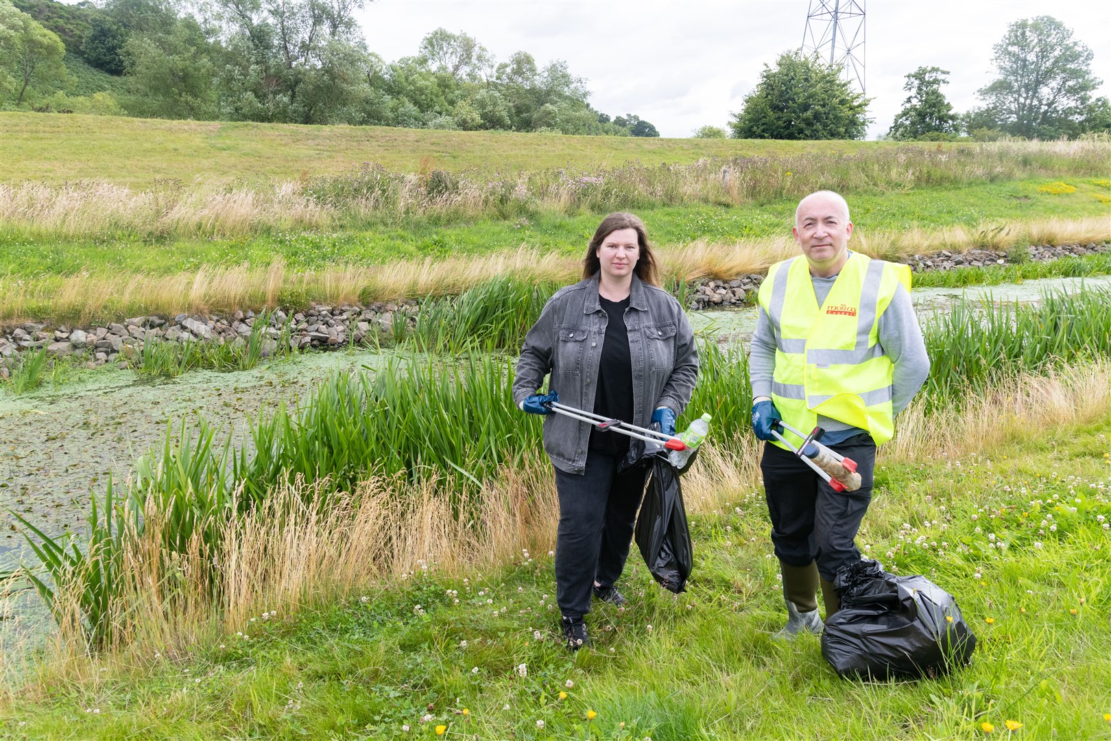 Councillors Amber Dunbar (Elgin North, Conservative) and Marc Macrae (Fochabers/Lhanbryde, Conservatives) litter picking along the flood alleviation beside Grampian Furnishers in Elgin...Picture: Beth Taylor.