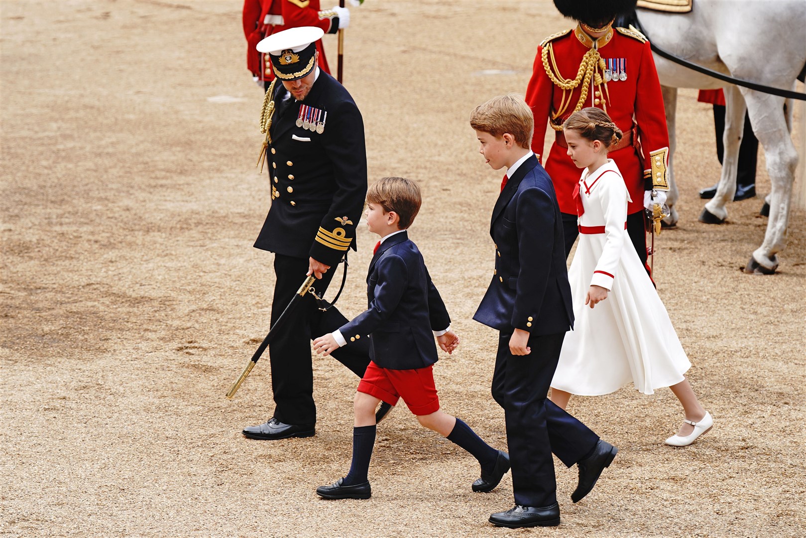 Prince Louis, Prince George and Princess Charlotte are escorted across Horse Guards to the dais (Aaron Chown/PA)