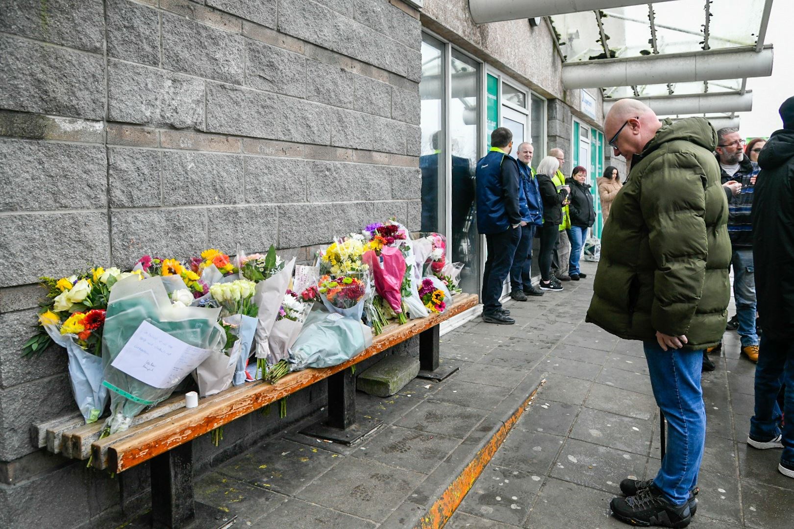 A mourner pays respects to Keith Rollinson at Elgin Bus Station. Picture: Beth Taylor