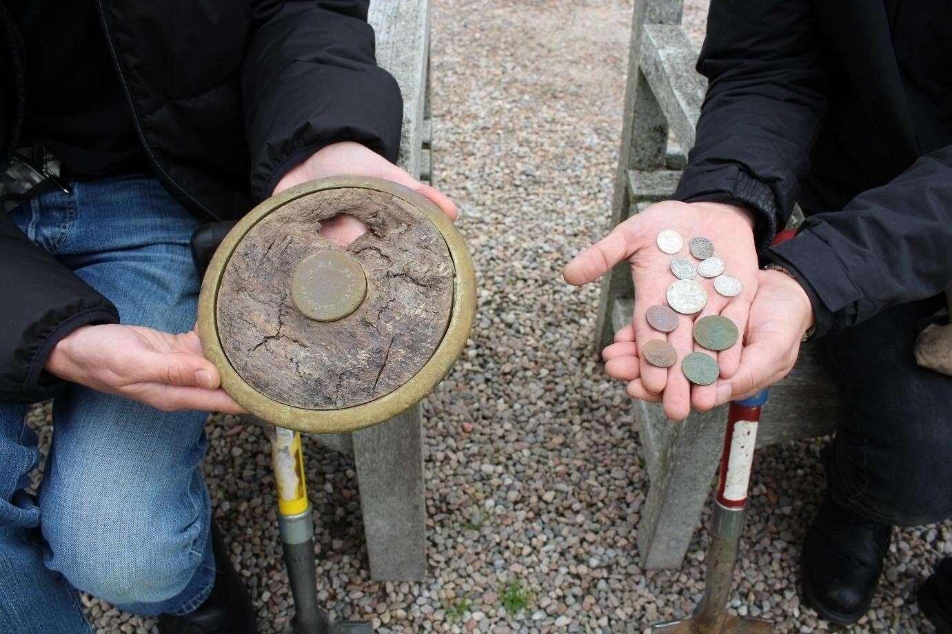 A throwing disc and a selection of coins found by Lee and John at Gordonstoun.