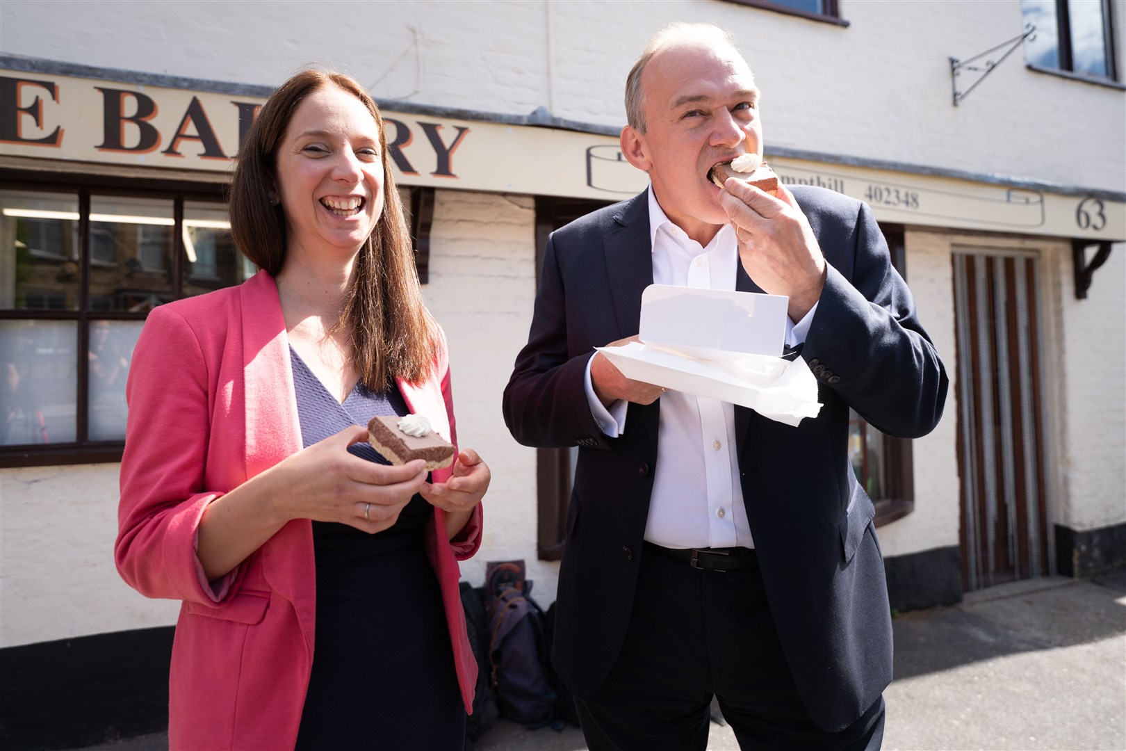 Sir Ed Davey and Lib Dem Mid Bedfordshire by-election candidate Cllr Emma Holland-Lindsay sampling local delicacies in Ampthill (Stefan Rousseau/PA)