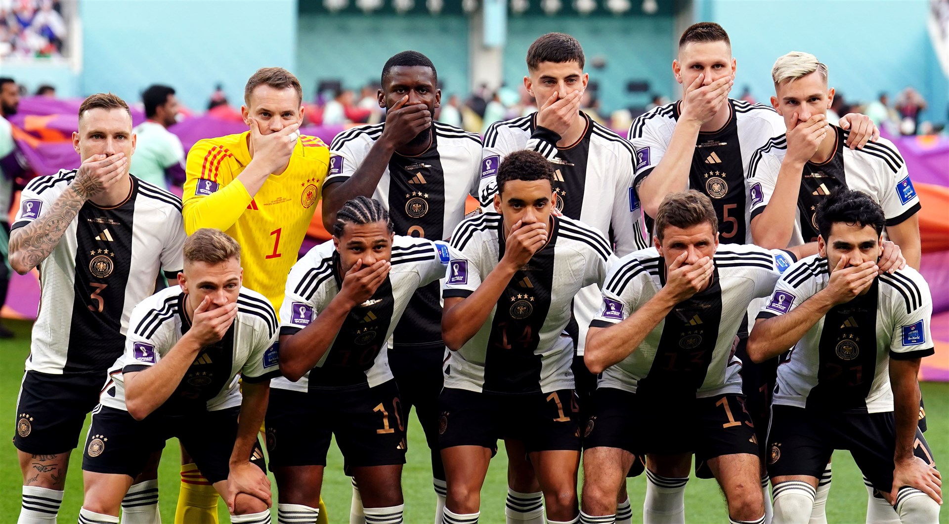 German players covered their mouths as they posed for a team photo ahead of their Group E match against Japan at the Khalifa International Stadium in Doha (Mike Egerton/PA)