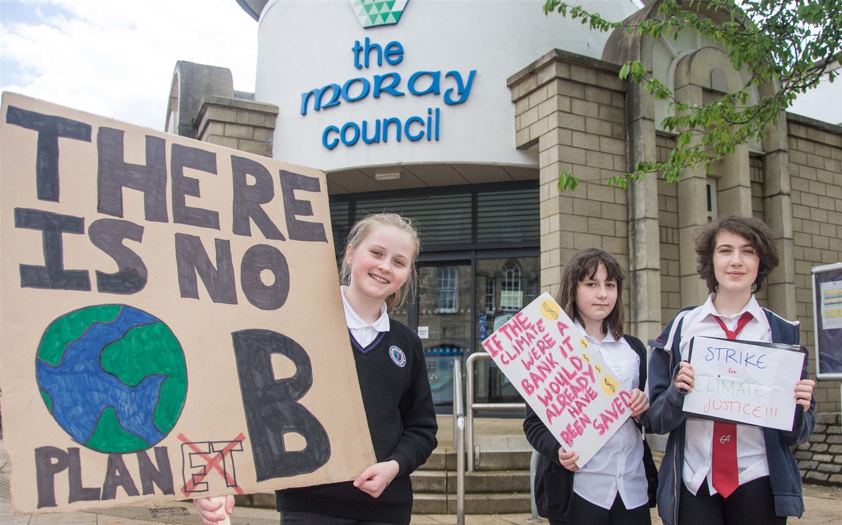 Protesters, from left, Hannah Weir, Bria Alexandra and Martha Allsop outside Moray Council HQ.