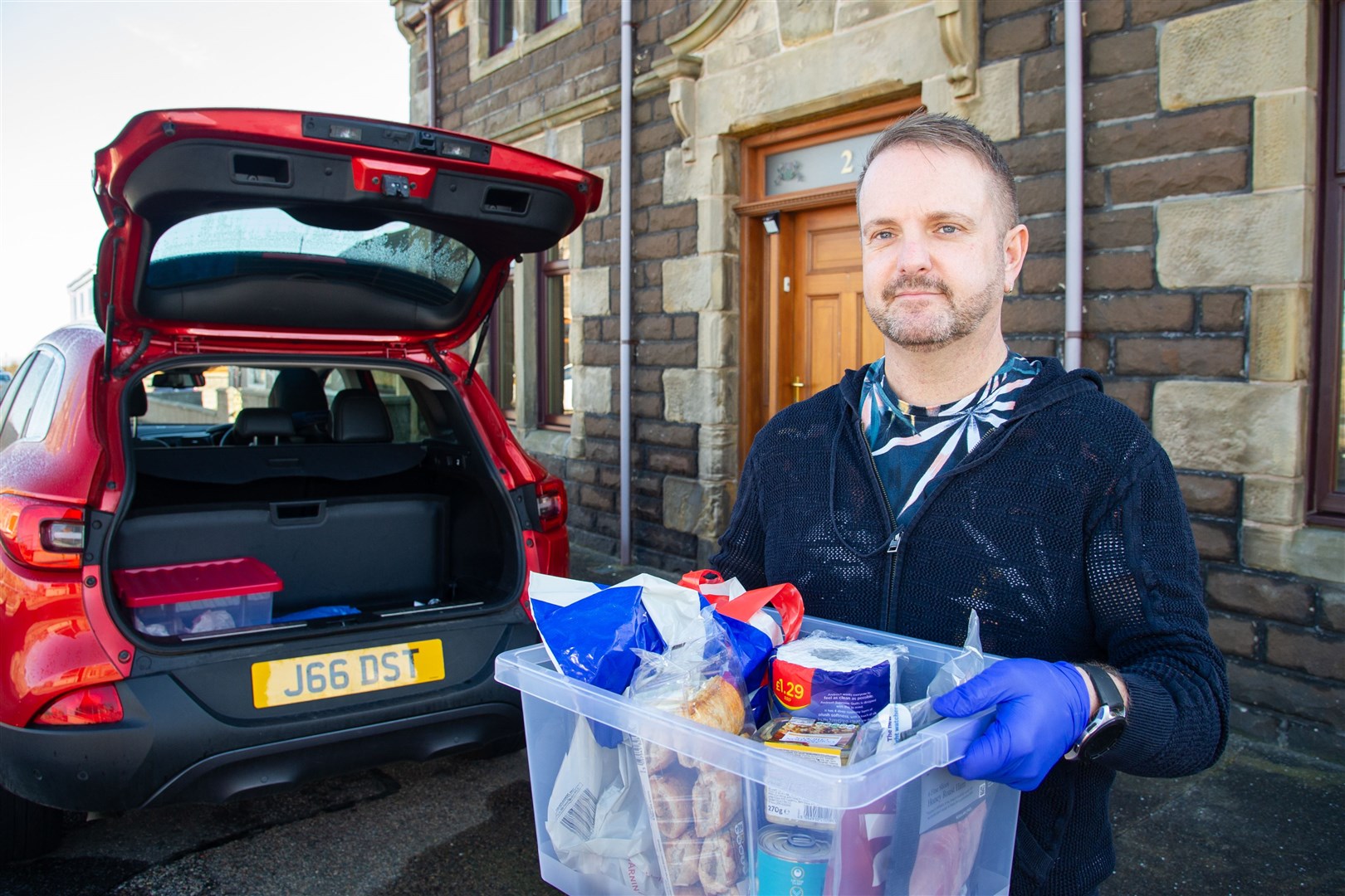 Buckie Kindness Group's John Stuart gets ready to go out with another delivery during lockdown last year. Picture: Daniel Forsyth.