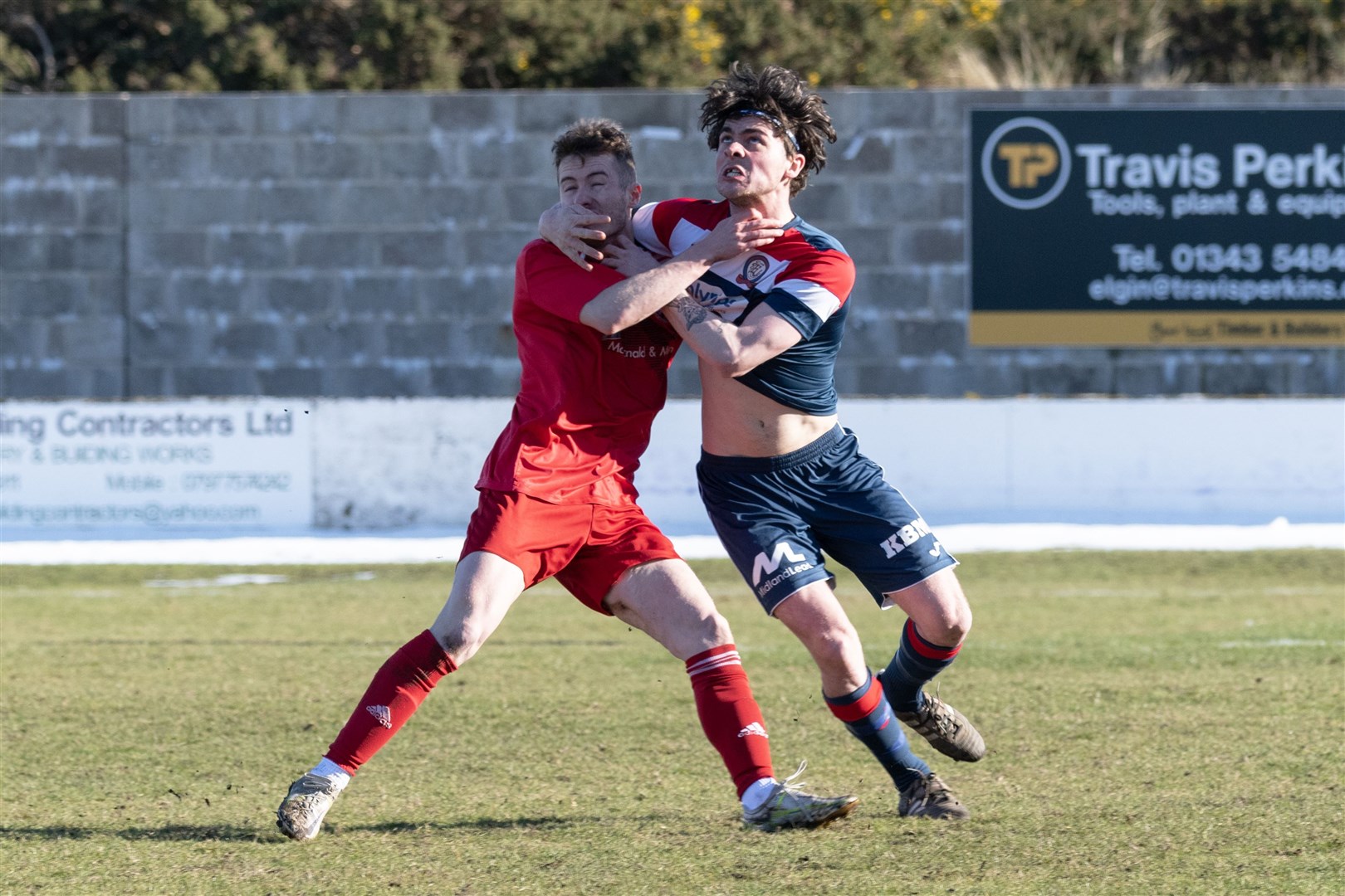 Lossie's Ross Morrison and Turriff's Liam Cheyne tussle to win the ball. ..Lossiemouth F.C. v Turriff United F.C. at Grant Park...Picture: Beth Taylor.