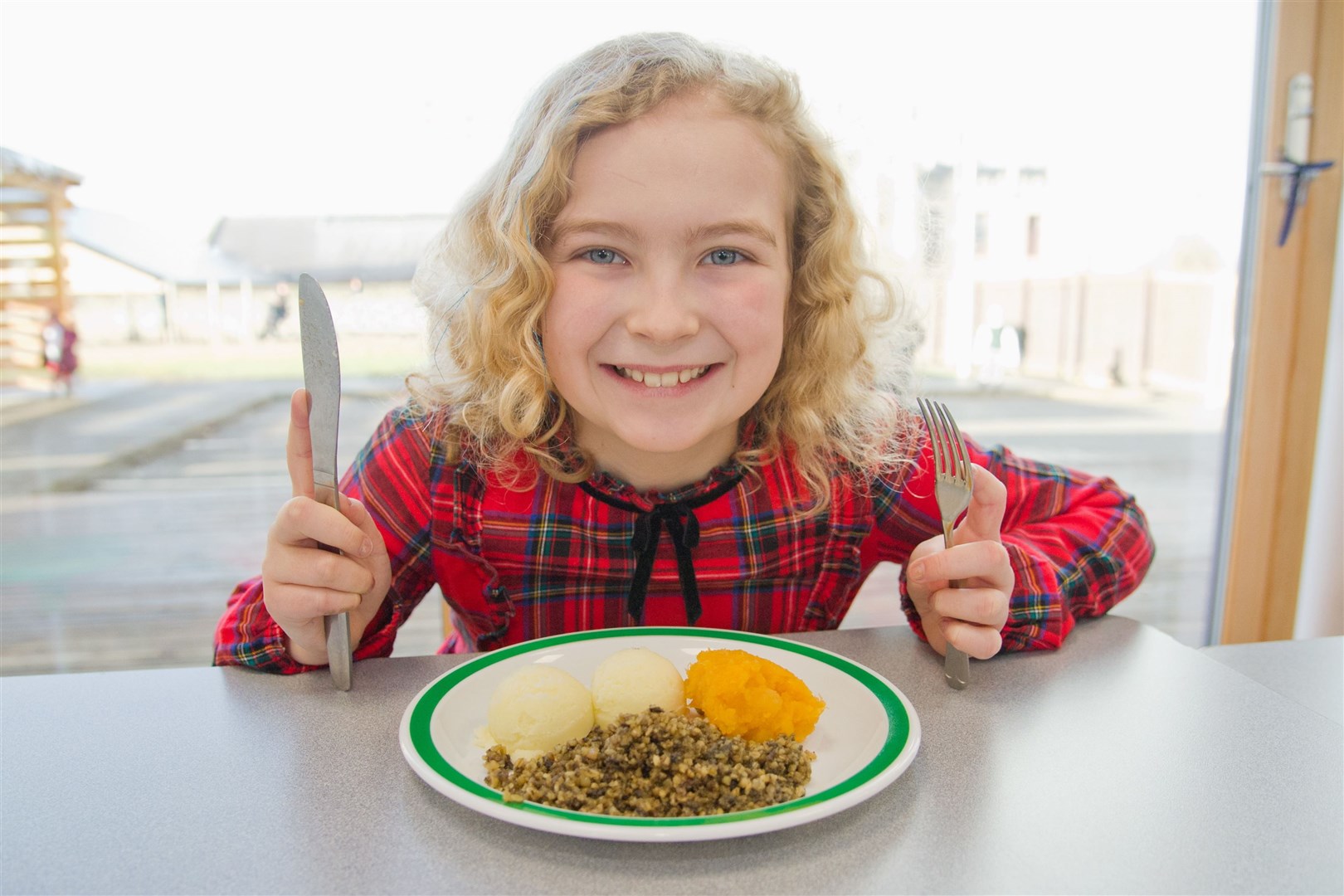 Milnes Primary School pupils Ava Brook gets ready to tuck into her Haggis, Neeps and Tatties..Picture: Daniel Forsyth.