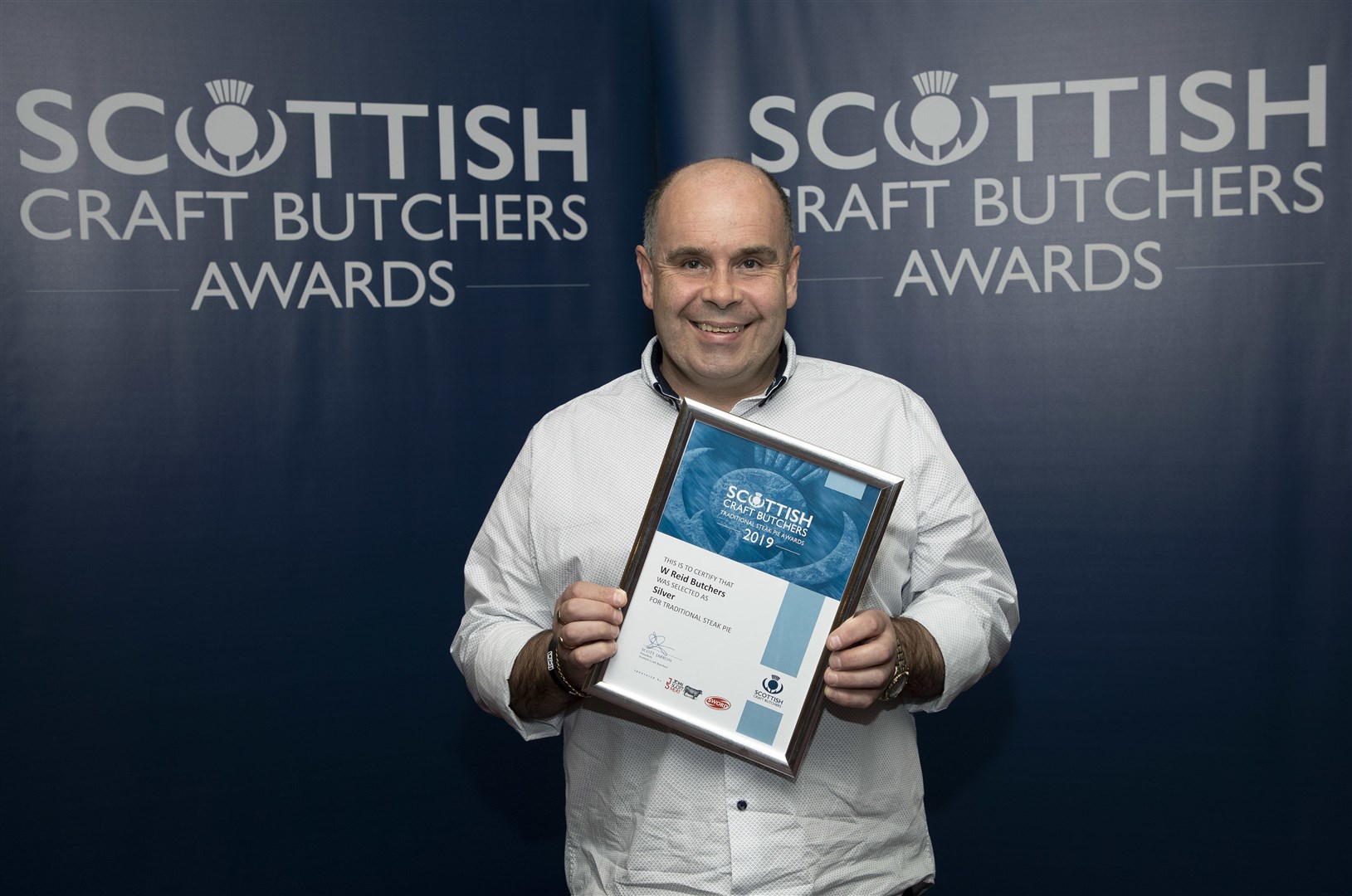 Phillip Robertson, from Hopeman's W Reid Butchers, with the award.