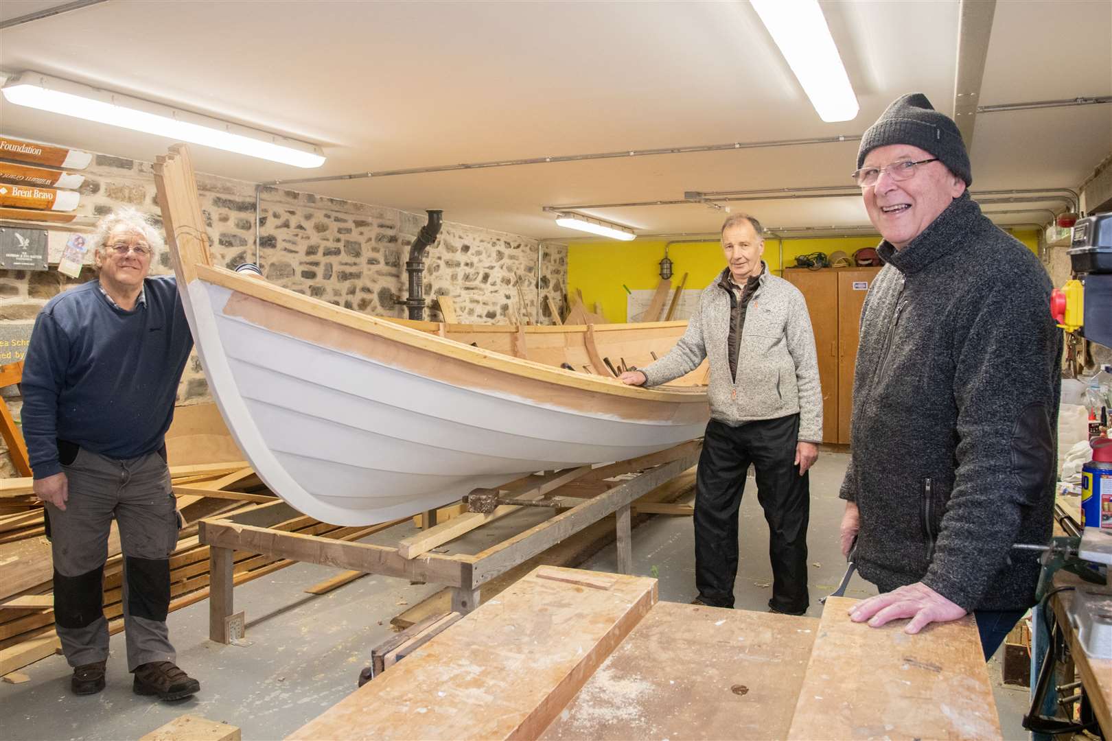 Relishing the challenge of building a skiff in memory of Prince Philip are (from left) Bert Reid, Willie Henderson and THA chairman Prof Ashley Mowat. They are pictured here working on a skiff in memory of late team member Bill Dunbar. Picture: Daniel Forsyth